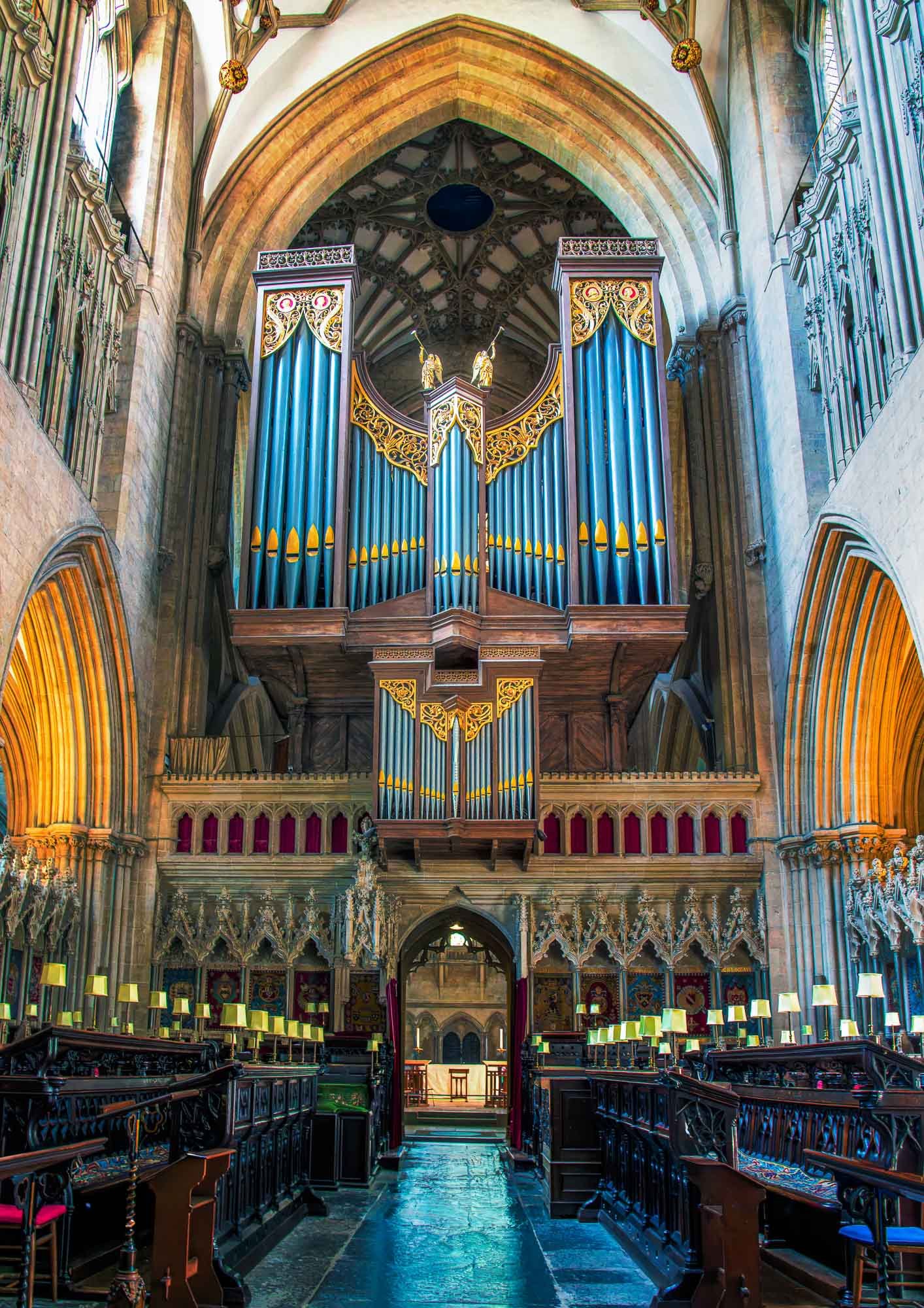 Organ at Wells Cathedral with Gothic arches and blue-gold pipes"
