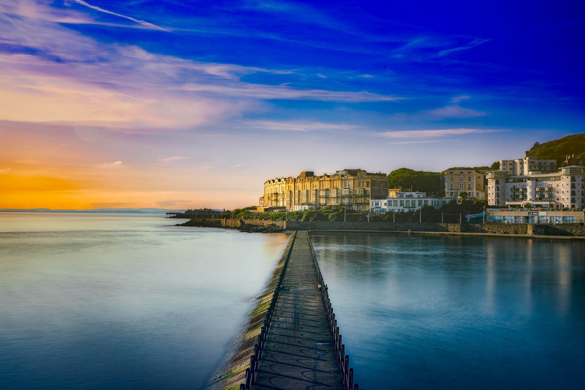 Evening light over Weston Super Mare with calm sea and town in the background