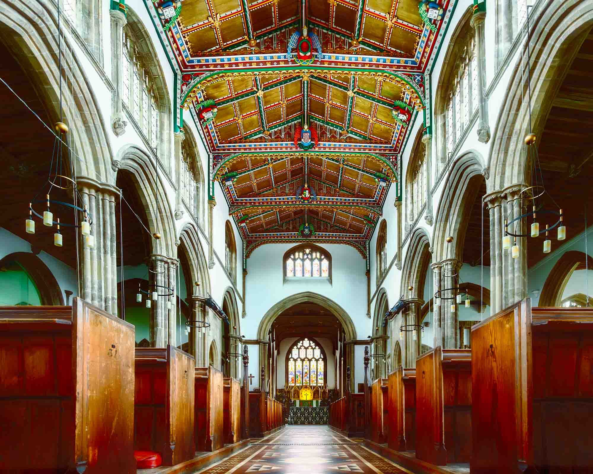 Ceiling of a richly decorated church interior in Somerset with red and green tones