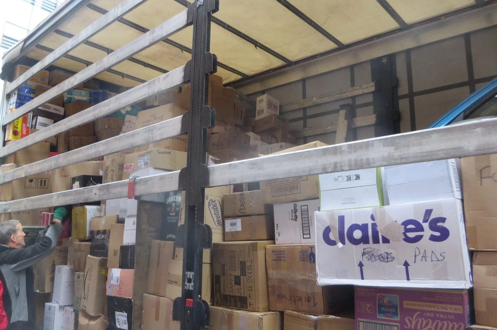 Cardboard boxes are loaded onto a truck which will make its way to Poland.