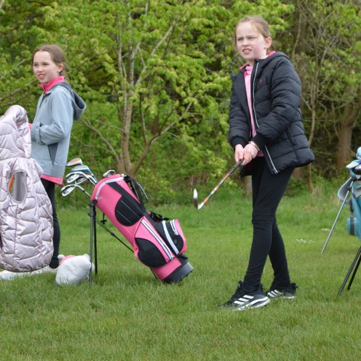 Girls golf lessons in Edinburgh: a girl golfer with her bag at the Girls Golf Hub, Swanston