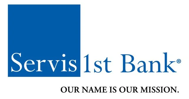 Logo of ServisFirst Bank with a blue square and white text that reads 'Servis 1st Bank' and the tagline 'Our name is our mission.'