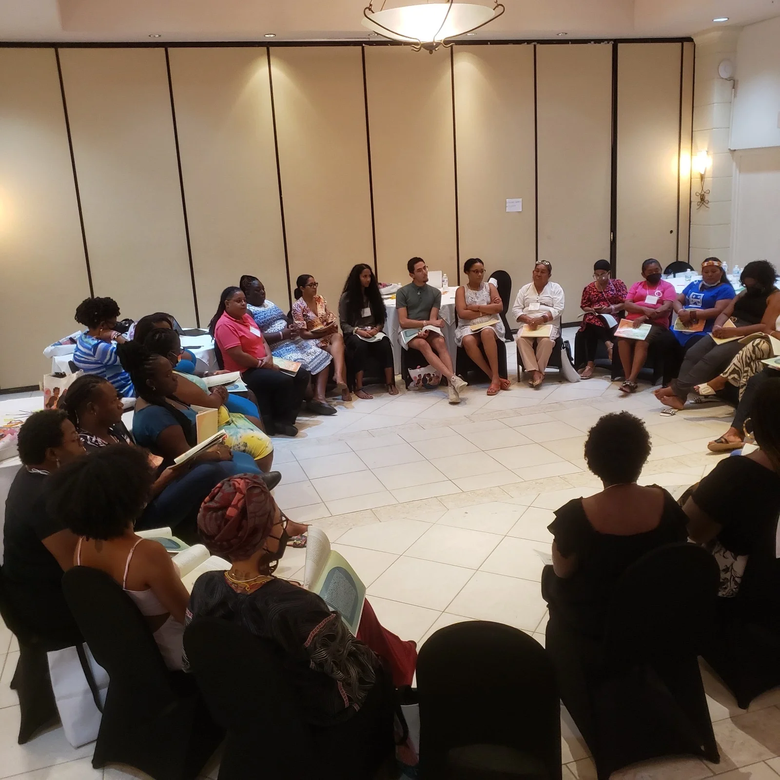 Intersect's resident artist, Lucia Murray (LEM), and former Intersect volunteer, Willum Watt, in group discussion at the WVL-Caribbean CommsLabs, organised by The Equality Fund and The Astraea Foundation in Barbados, 2022.