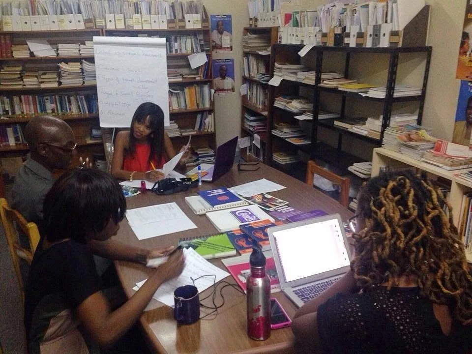 Intersect's co-founders Sarah-Anne Gresham and Nneka Nicholas preparing for the Orange Flash rally with the Directorate of Gender Affairs. 