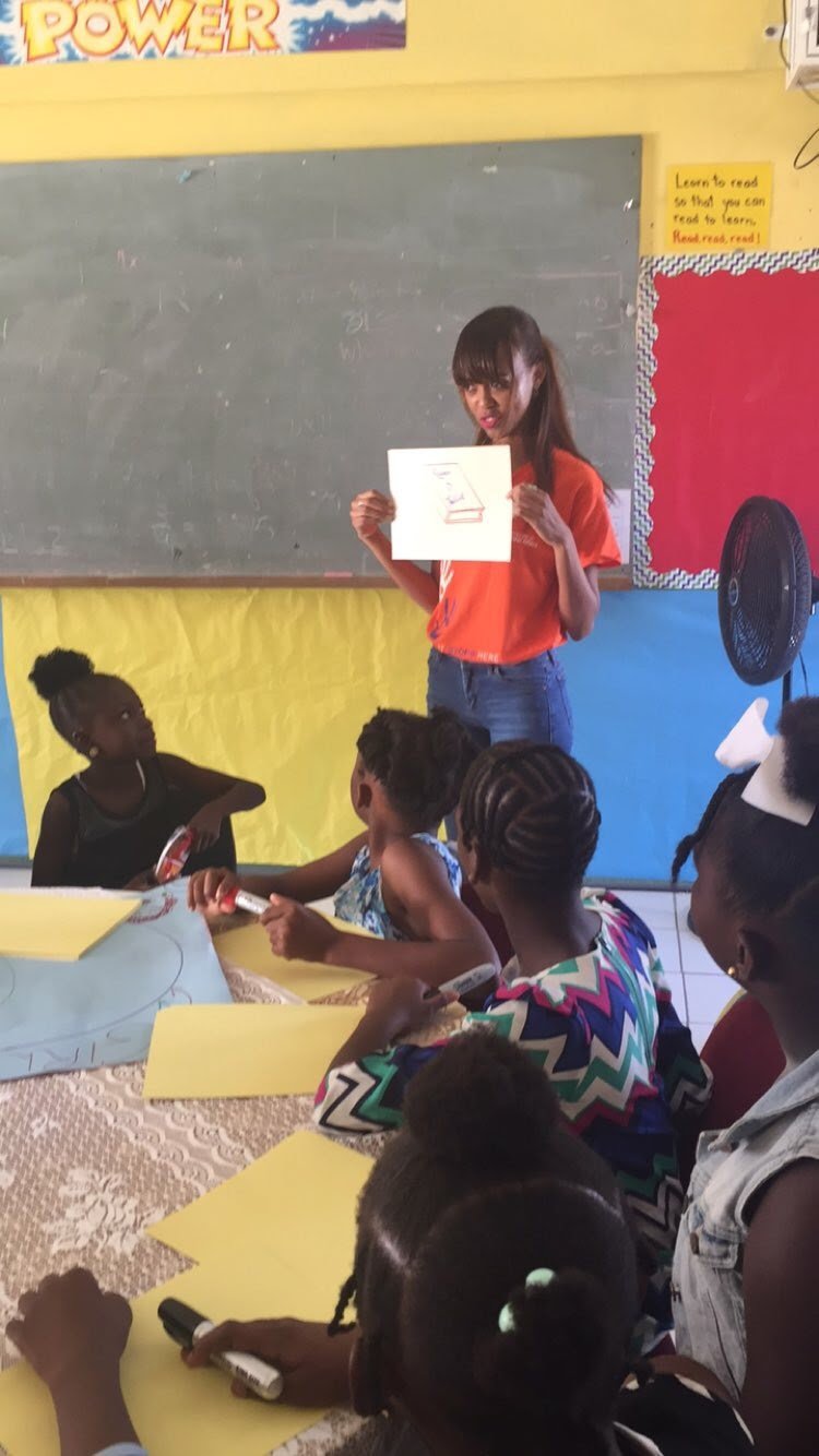 Sarah-Anne Gresham, co-founder of Intersect Antigua-Barbuda and former research officer at the Directorate of Gender Affairs engaging primary school students on gender and self esteem.