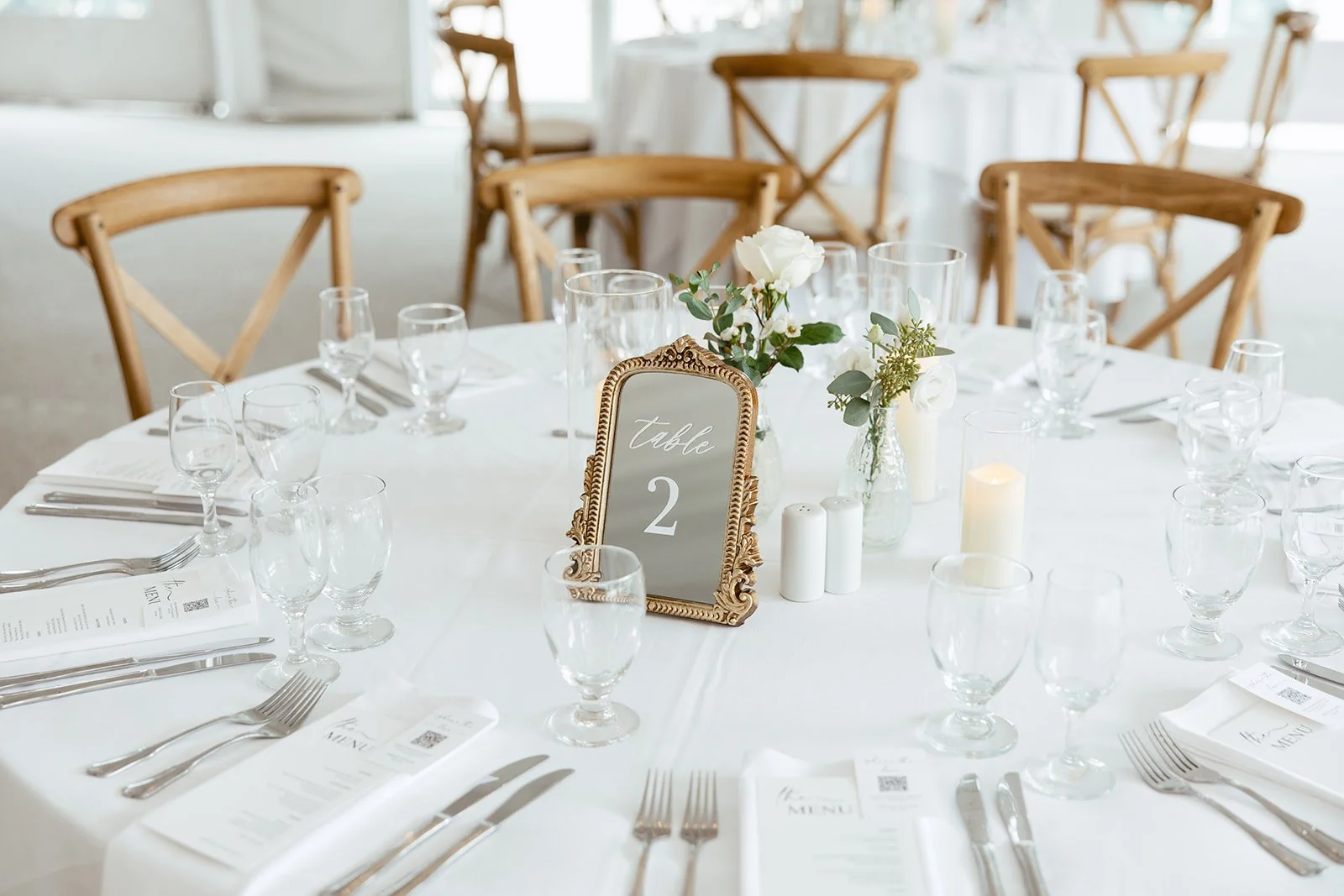 Wedding table details with gold accents and greenery