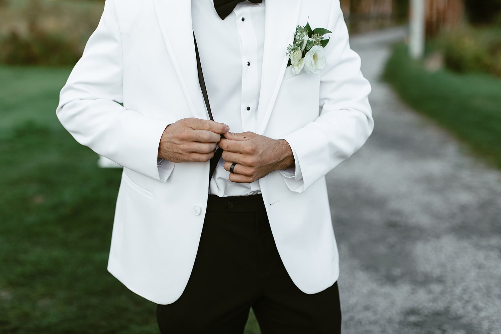 Groom with black and white tux details