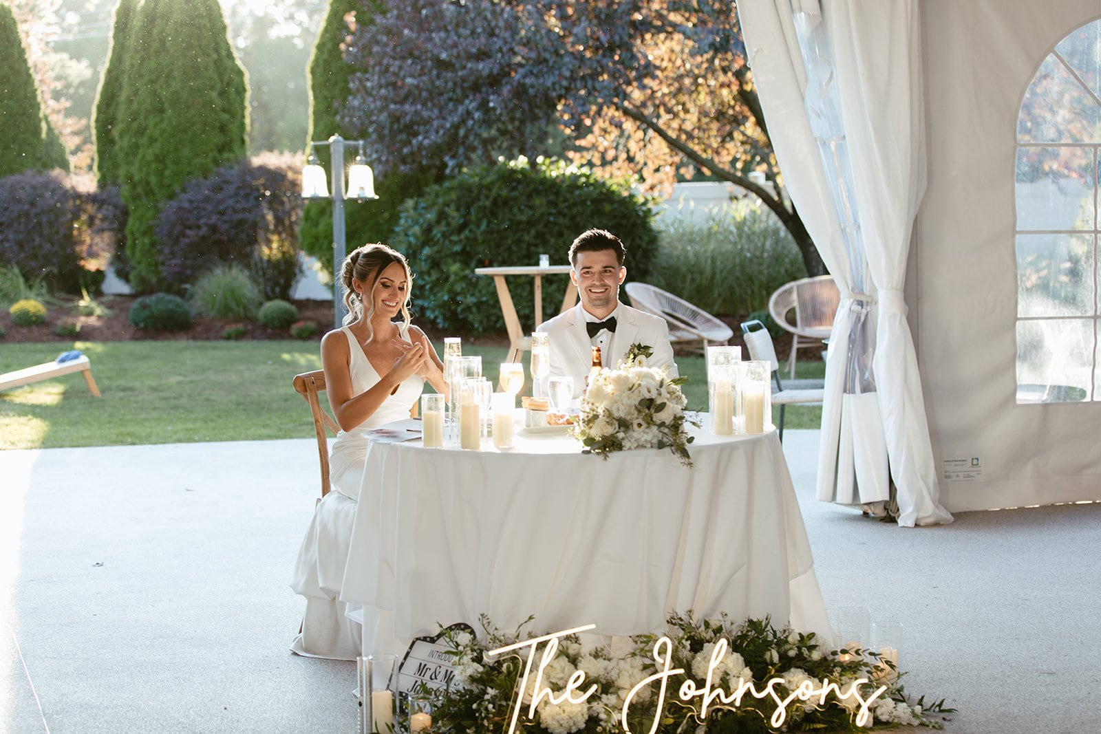 Wedding couple laughing during reception toasts