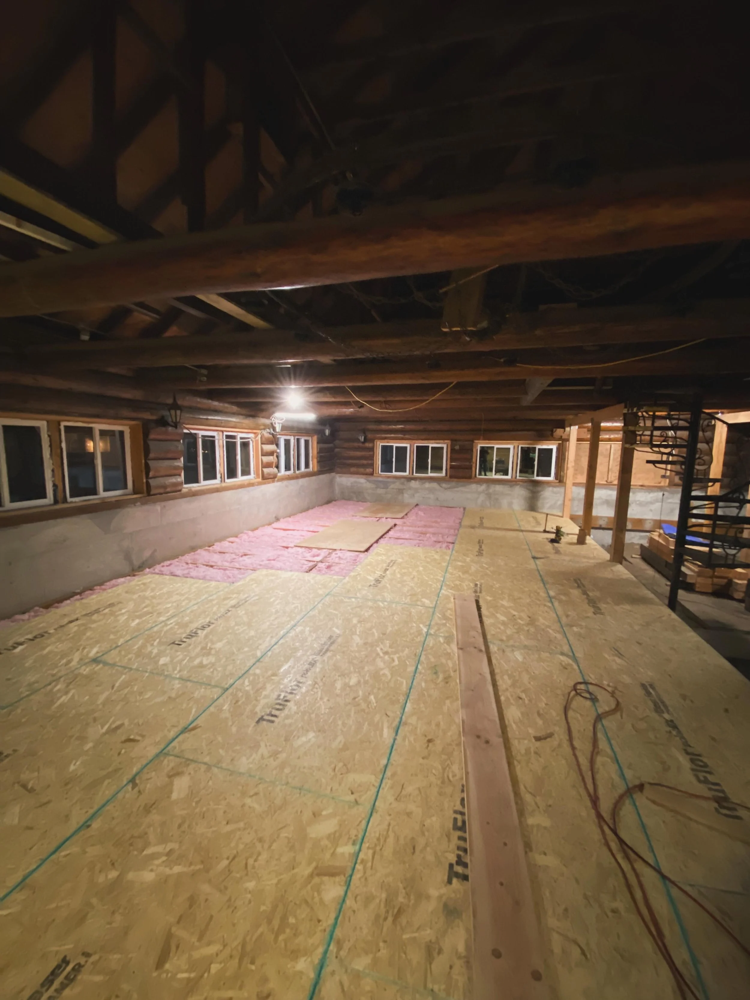 Winter of 2025 was at its peak and the lodge was freezing even with the new insulation in place, but it was finally time to lay down the subfloor. We had moved in two large stacks of different types of plywood at the beginning of the year and it felt