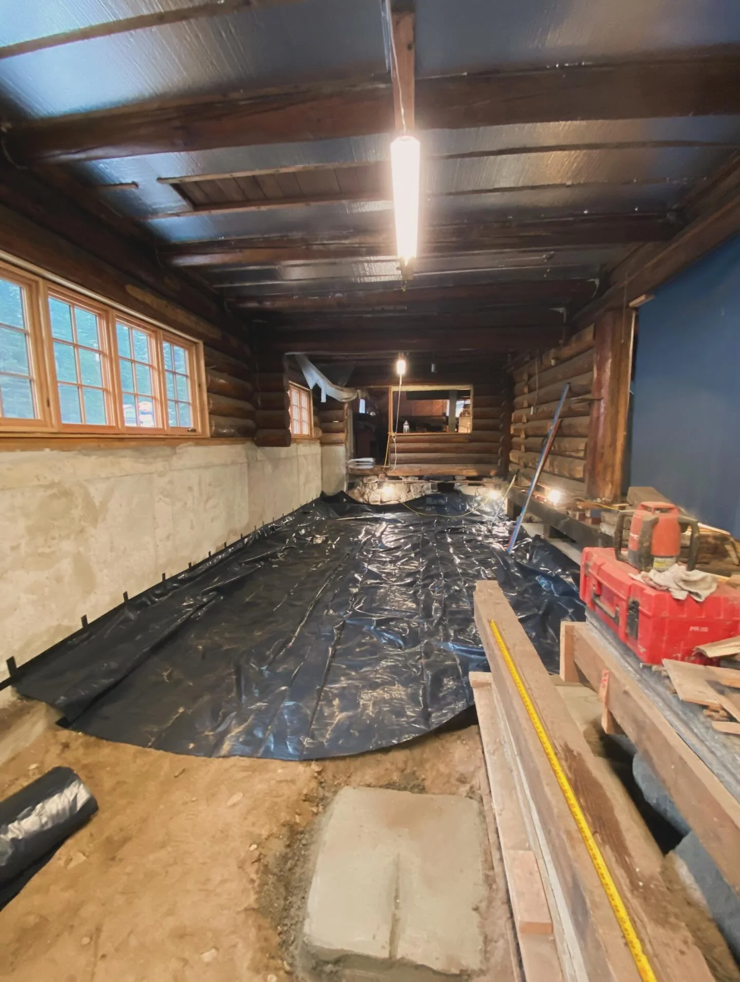 November and December of &lsquo;24 also saw the beginnings of a floor appear in the front parlor. We had it dug out to accommodate a lower floor and the crawl space beneath. Next step was to cover the entire space with a thick layer of plastic to blo