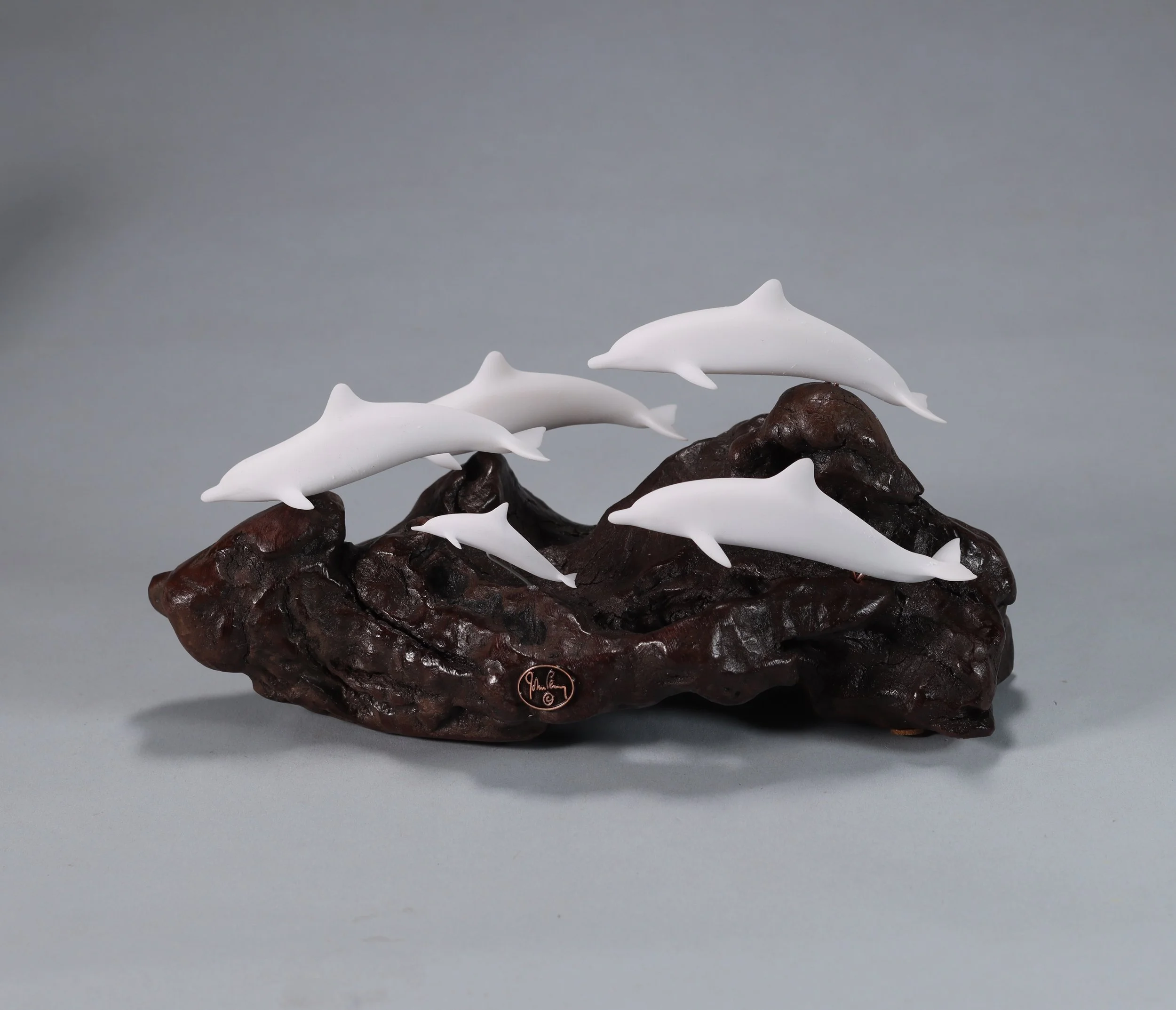 School of Dolphins Sculpture (4 Adults and 1 Calf) 8in Long Pellucida on Polished Burlwood Base. Signed.