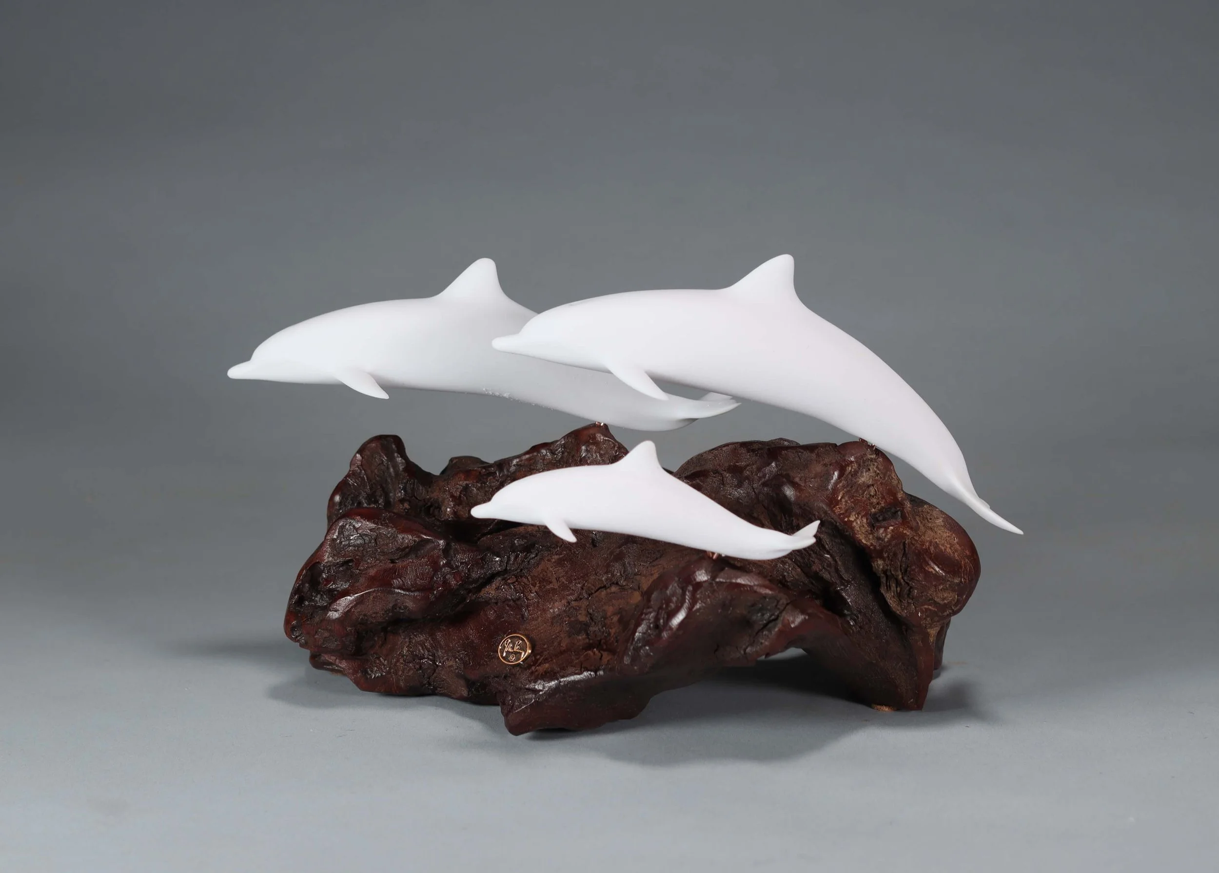 Family of Dolphins Sculpture (2 Adults and 1 Calf) 10in Long Pellucida on Polished Burlwood Base. Signed.