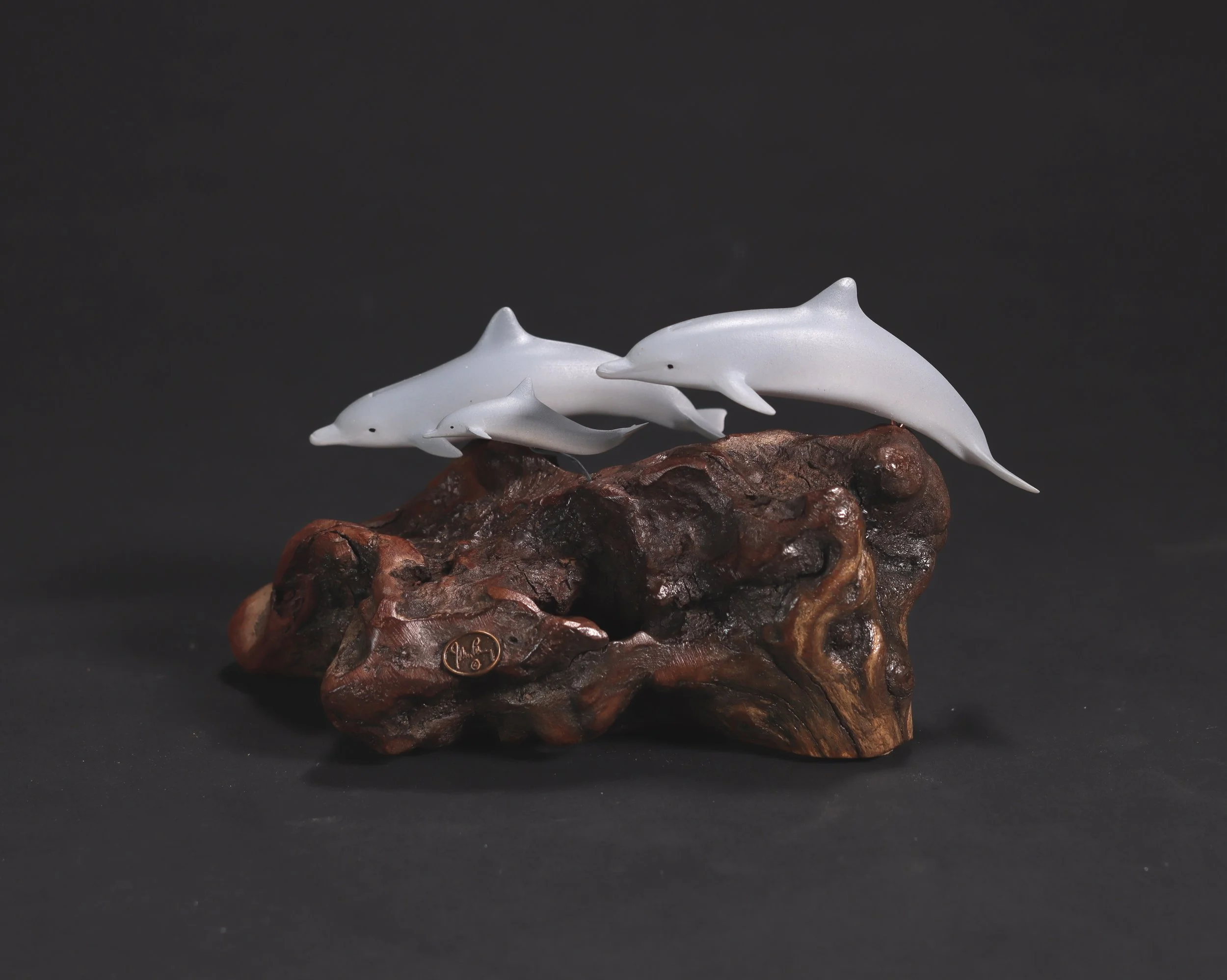 Family of Dolphins Sculpture (2 Adults and 1 Calf) 5in Long Airbrushed on Polished Burlwood Base. Signed.