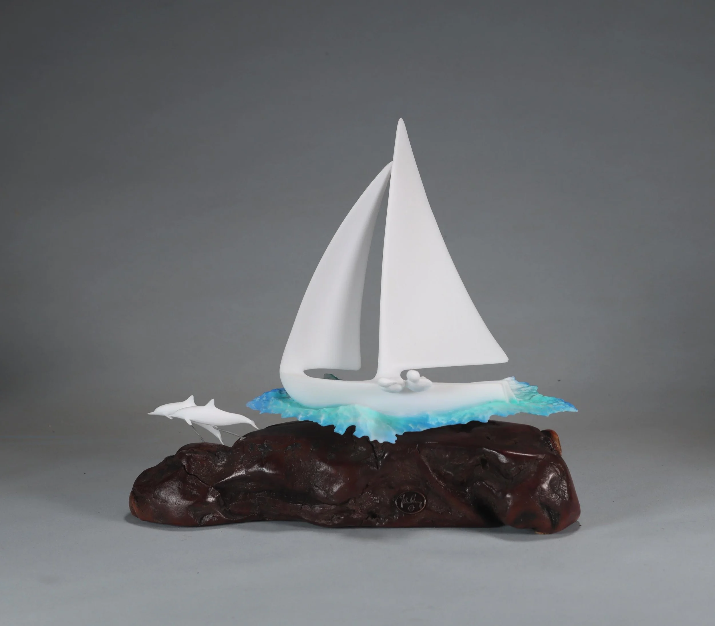 Sailboat With 2 Dolphins and crew Sculpture 9in Tall Pellucida on Burlwood