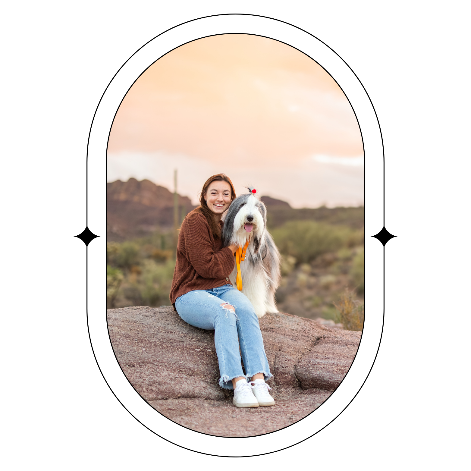 Woman and pup in the desert with a orange and pink sunrise behind them