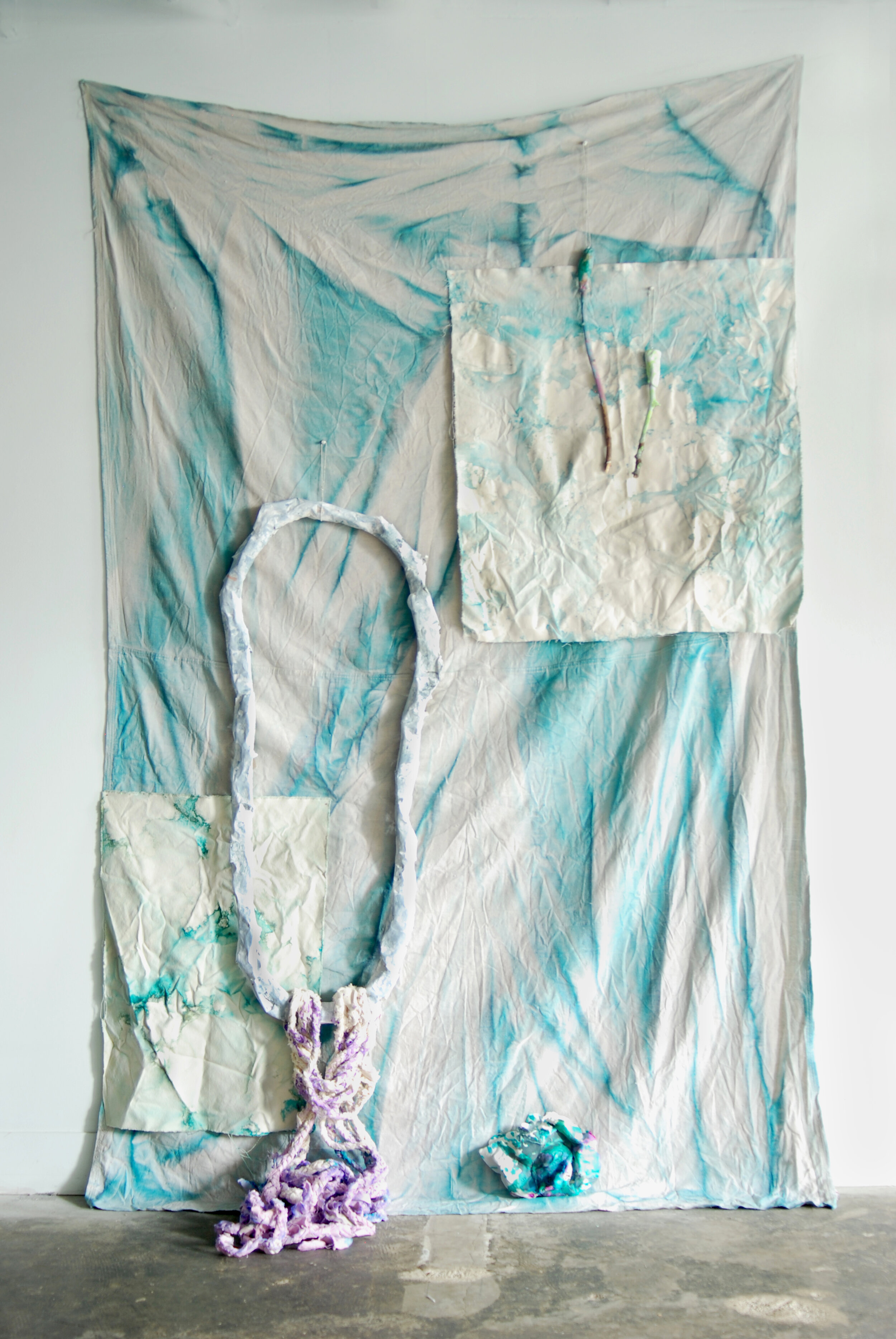   Three Dreams of Drowning #3 , 2015 Dyed canvas dropcloth, plaster, salt dough, sticks, paper mache, acrylic, watercolor, gouache, latex paint, string, ball chain, pins, nails, t-shirt and three dimensional floor  components on wood plinths 108 x 72