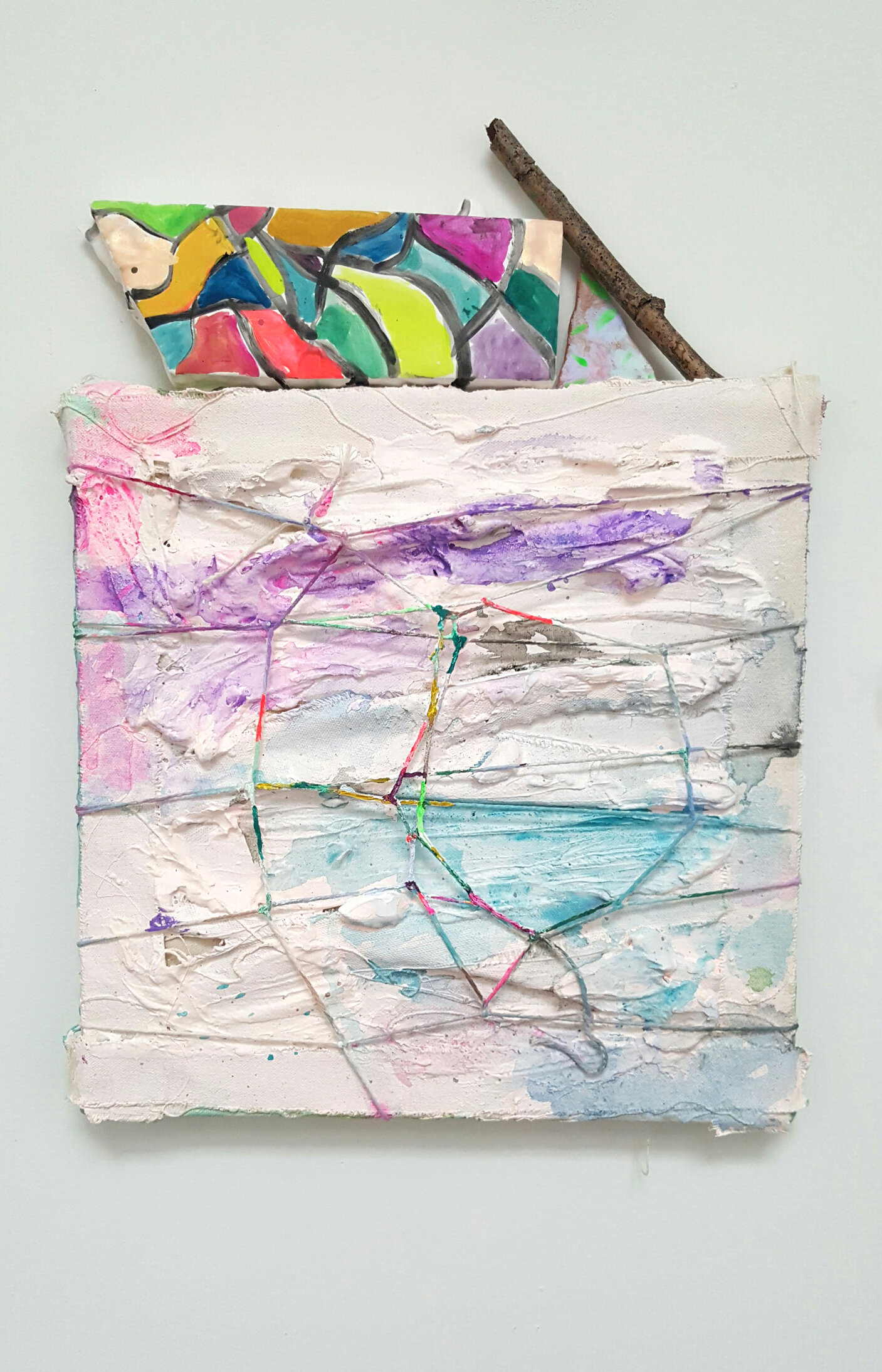   The silver branch and the small white flower , 2016 Plaster, acrylic , watercolor, painted twine, found stick, self firing clay on canvas 12 x 12 inches  