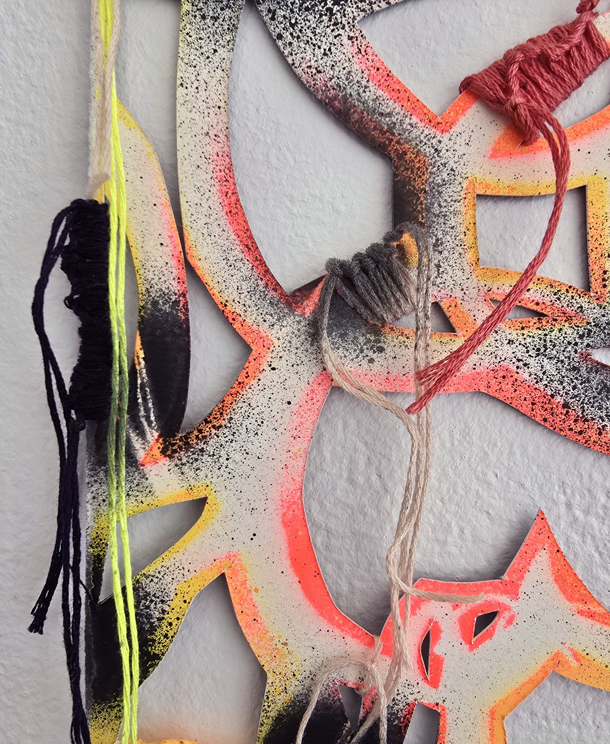 Wah-wah , 2025, detail Spray paint, woven embroidery floss, and artist’s tape on hand cut paper 16 × 7 inches