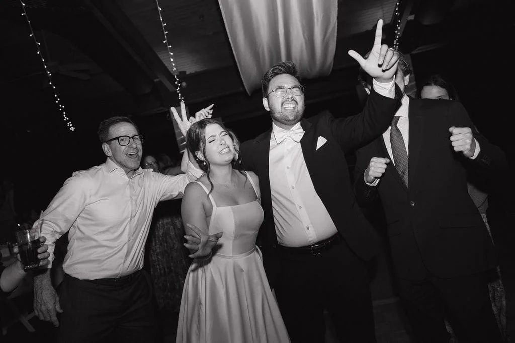 Bride, Groom and other people celebrate joyfully at a wedding