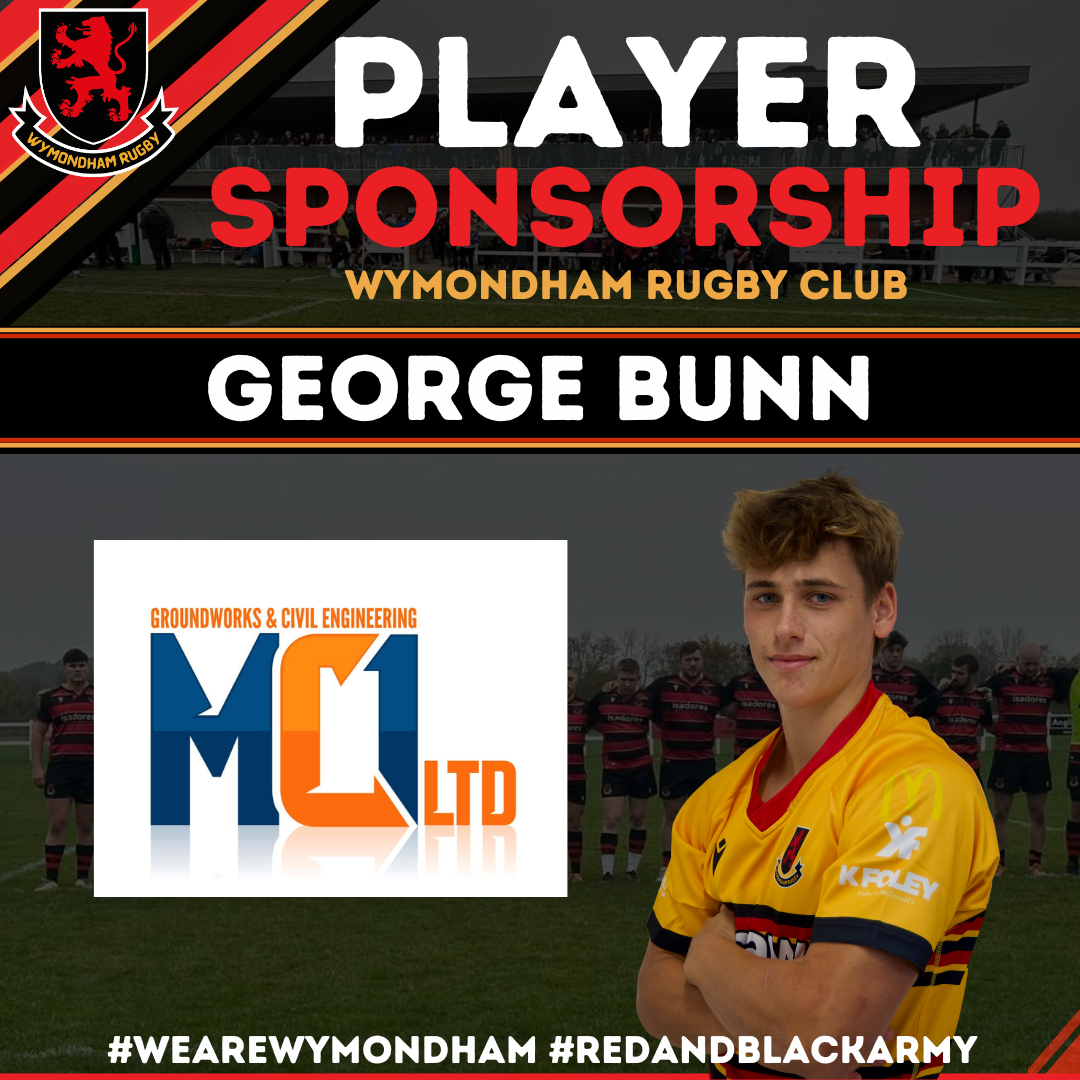 A football player in a yellow jersey with arms crossed, standing in front of a rugby team line-up on a field, with a sponsorship banner and Wymondham Rugby Club logo in the background.