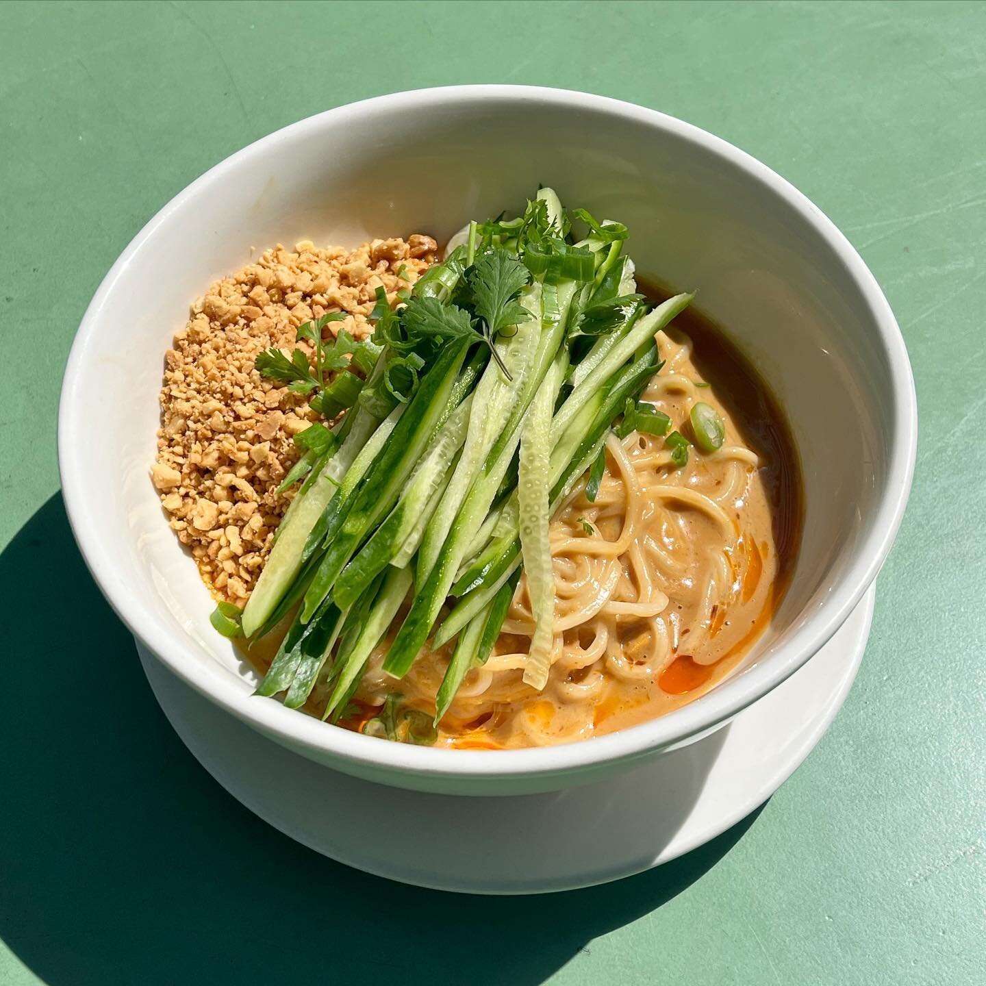 ~DAN DAN NOODLES~ 
Rich sesame peanut sauce, fragrant chili oil, crushed peanuts, fresh julienned cucumbers and scallion. Perfect for a sunny day on the patio, a gray day in front of your TV, honestly just pretty perfect. Available at all locations!