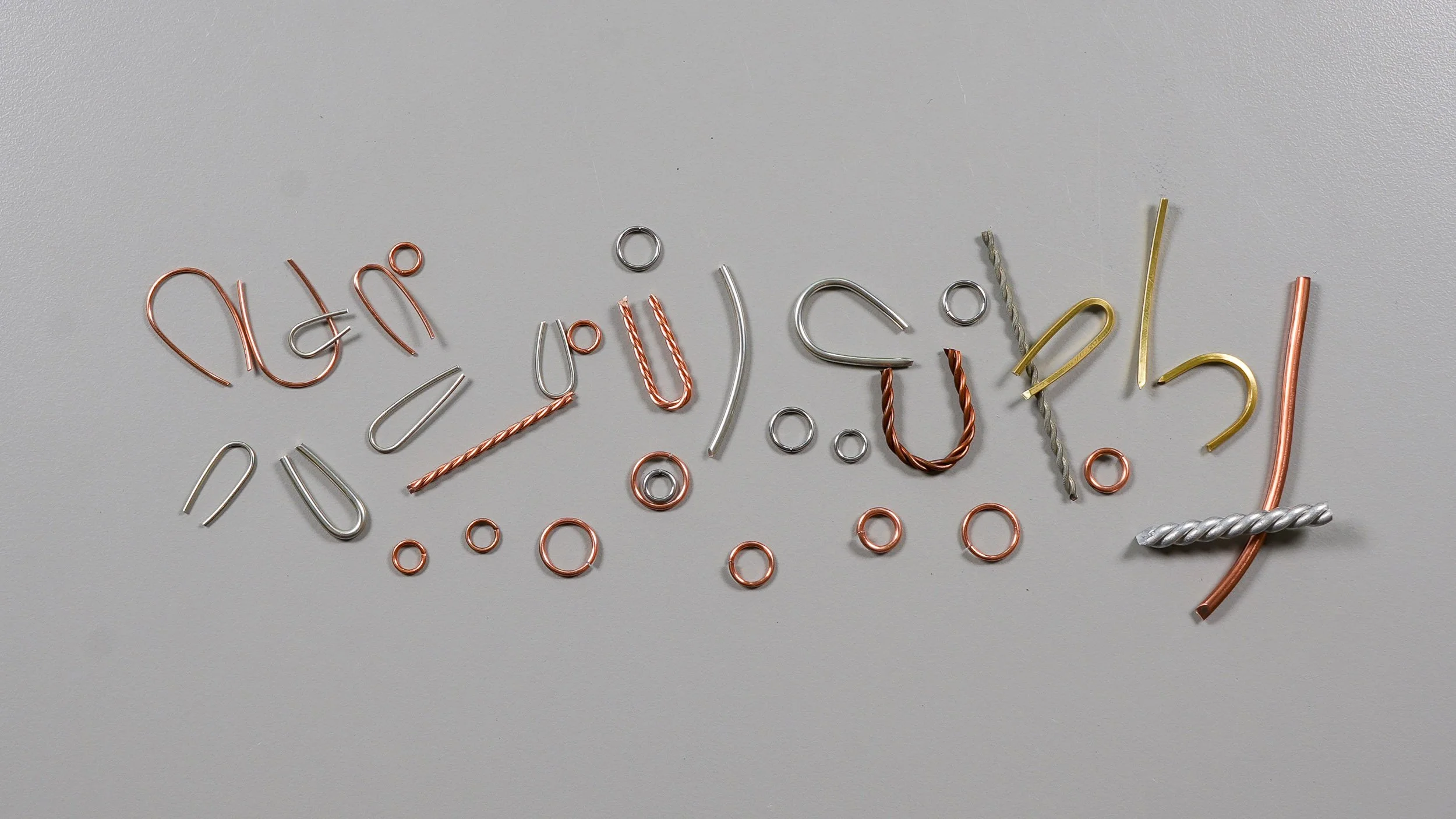 Numerous wire loops and jump rings of various shapes, sizes, and materials