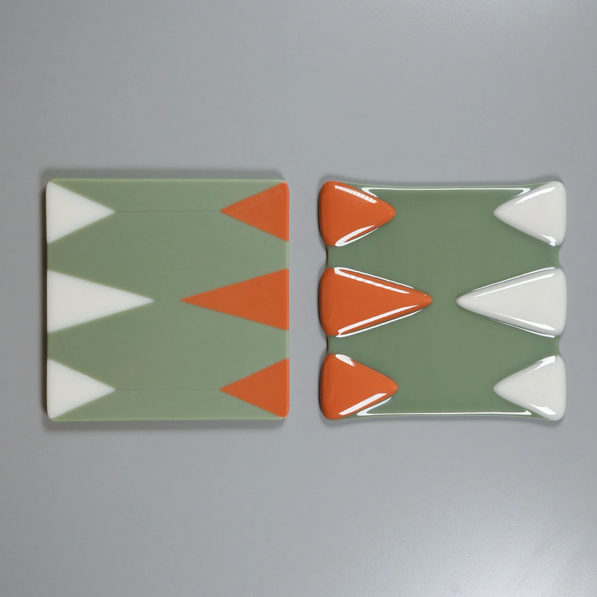 Two fused glass projects with the same design, but one having flat, sharp shape outlines, and the other having soft, rounded shape outlines