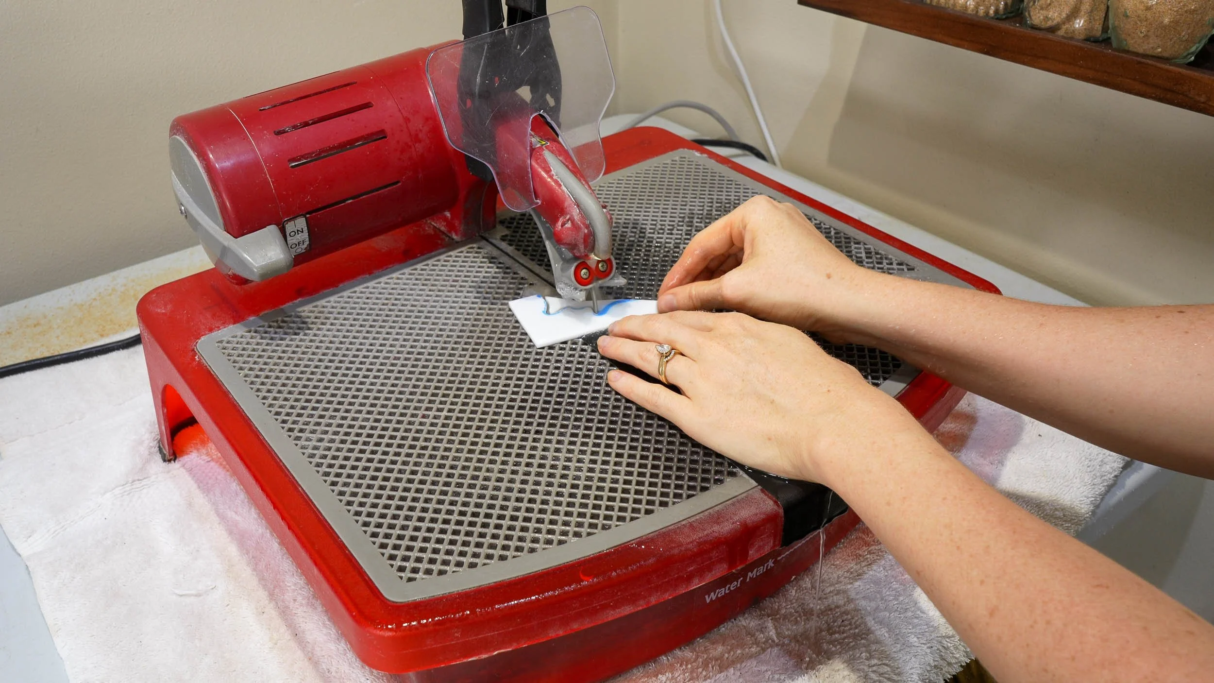 An electric ring saw being used to cut a complex stained glass shape