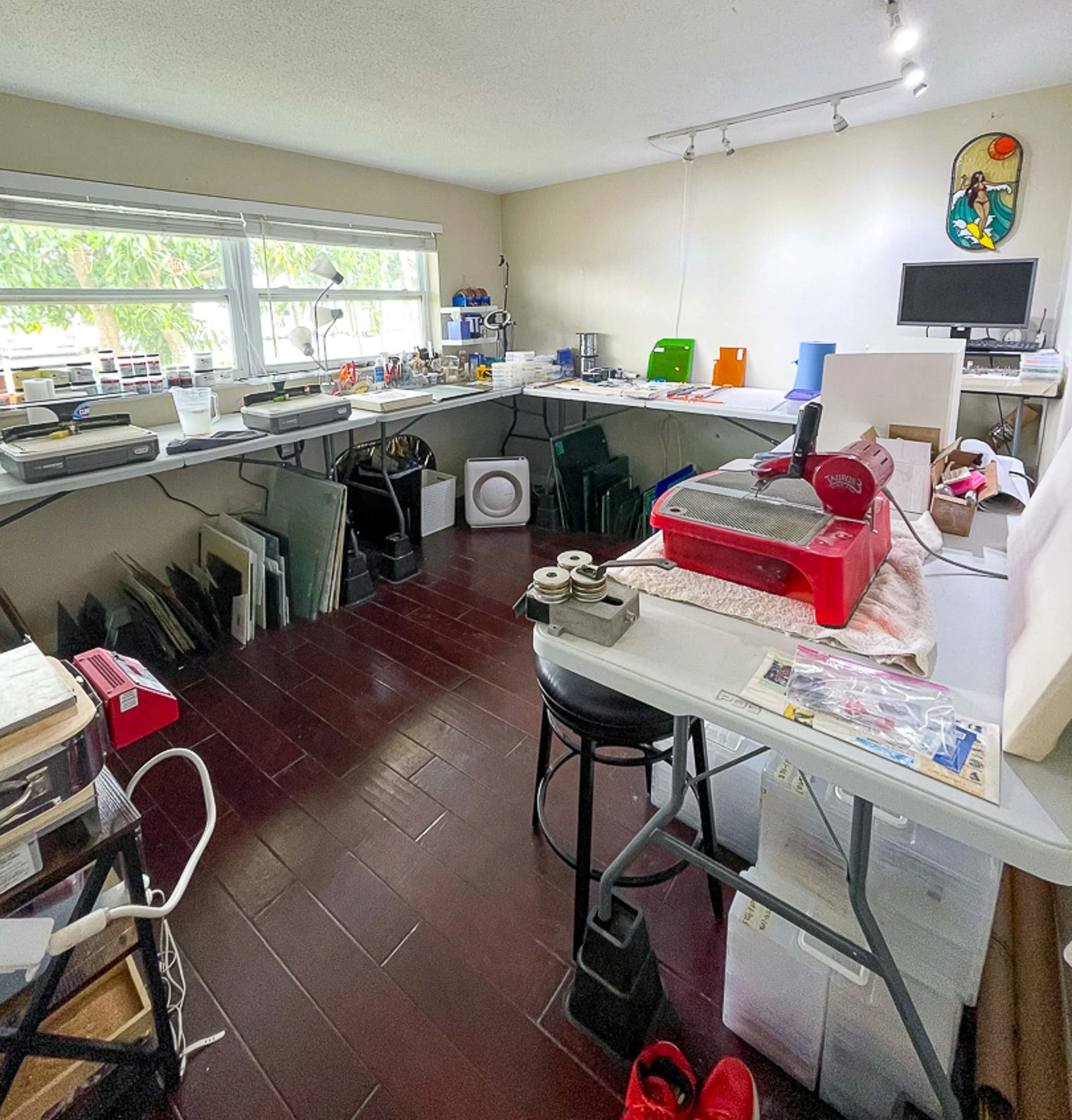 A glasswork studio setup within a spare bedroom space