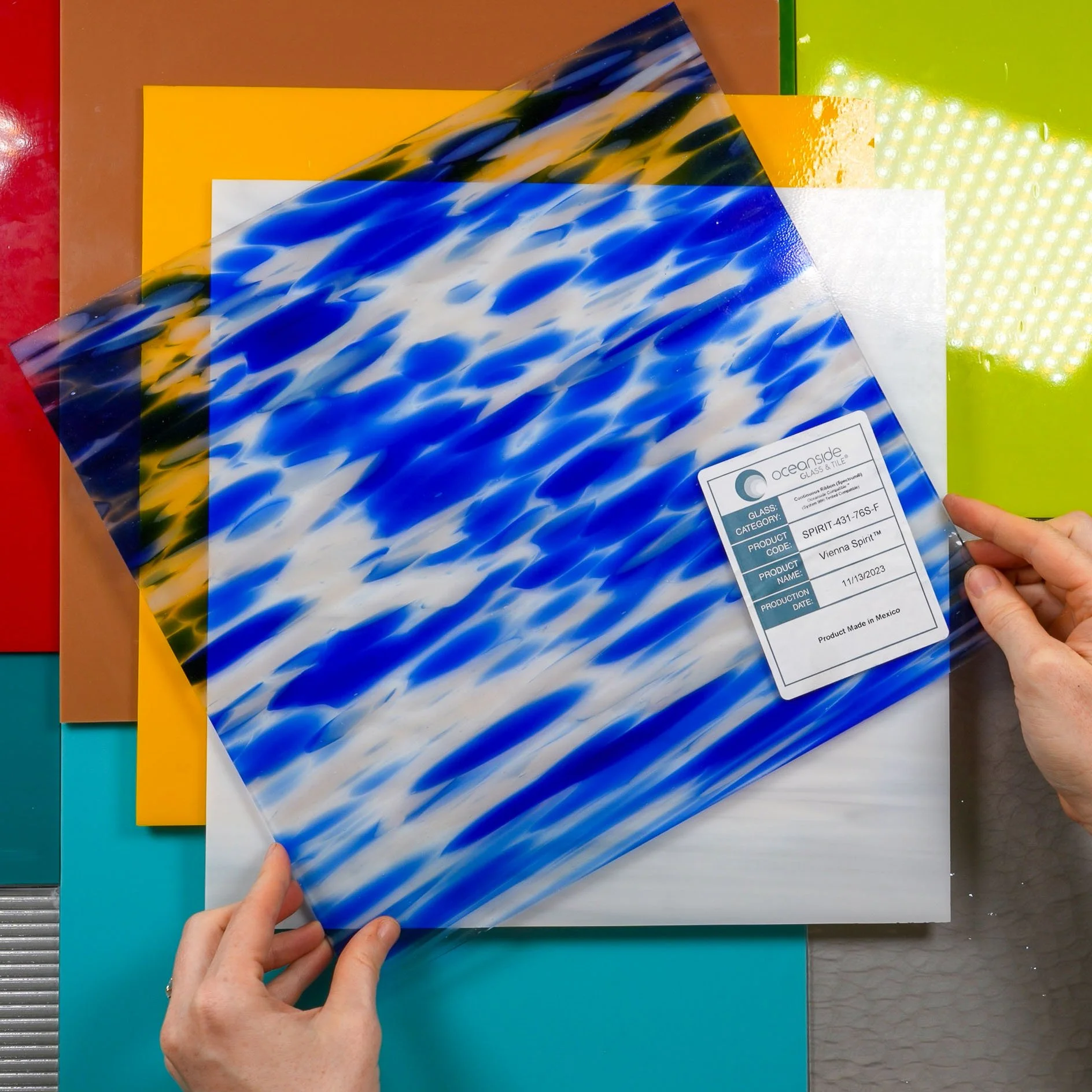 Several colorful stained glass sheets manufactured by Oceanside Glass™