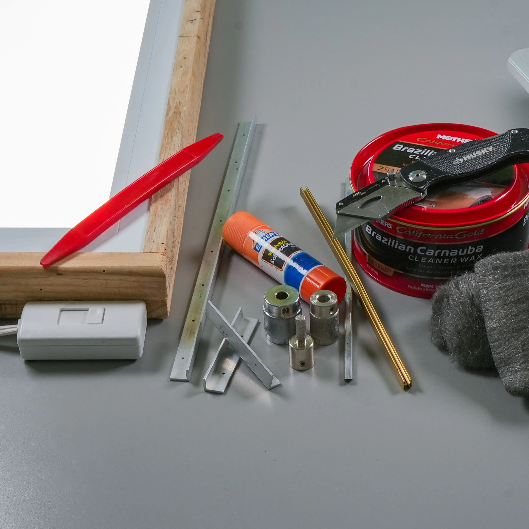 Various stained glass tools and materials arranged on a work surface