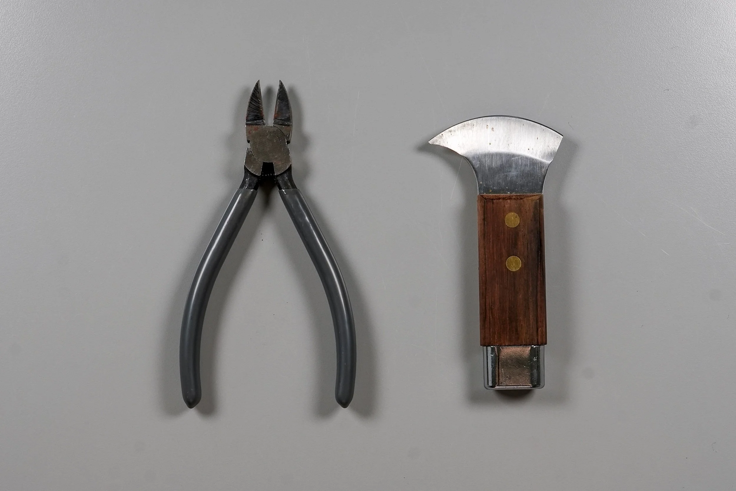 A pair of lead nippers next to a lead knife