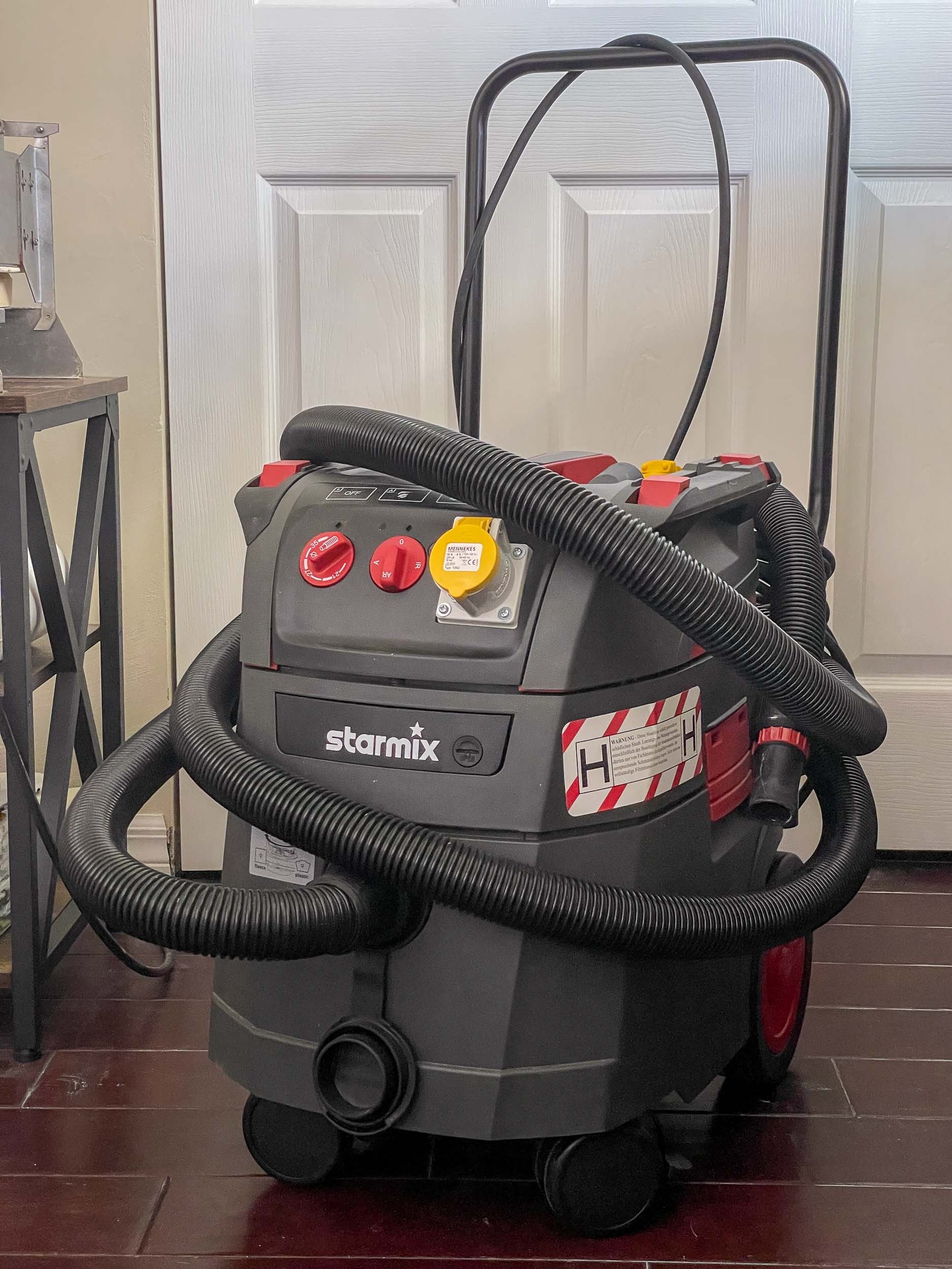 A Starmix shop vac equipped with an H-class filter within a stained glass home studio