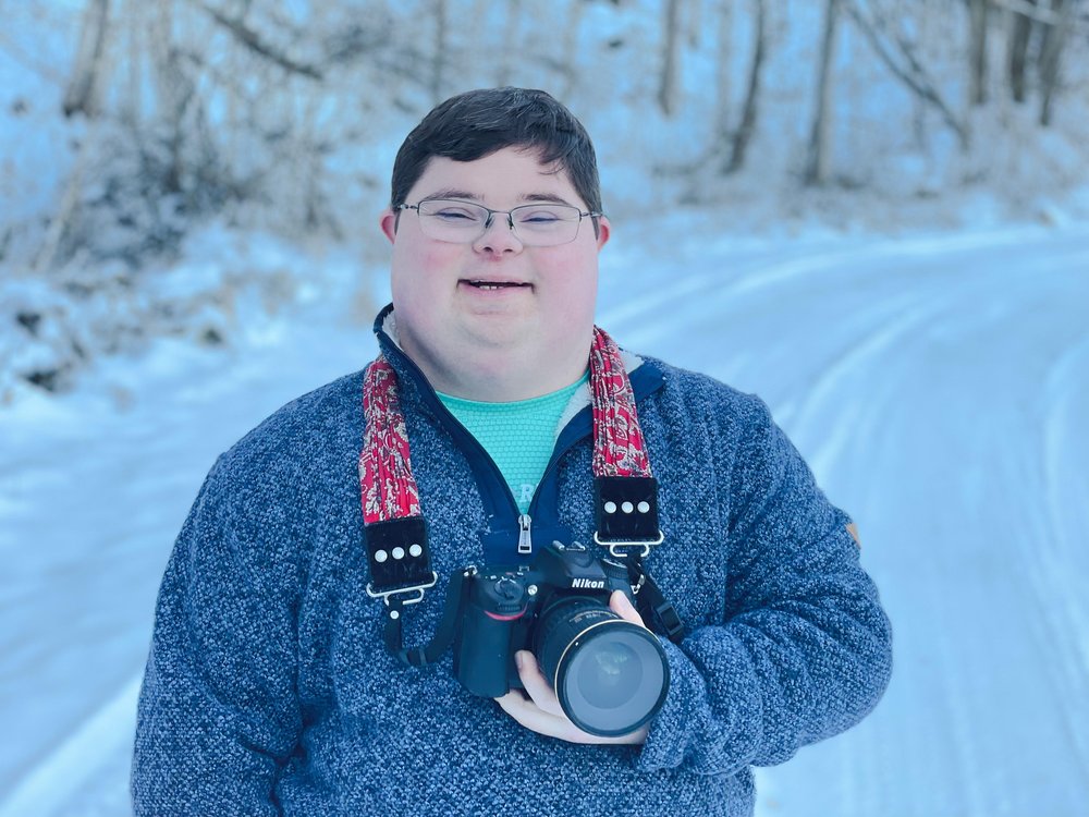  Houston holding the camera around his neck 