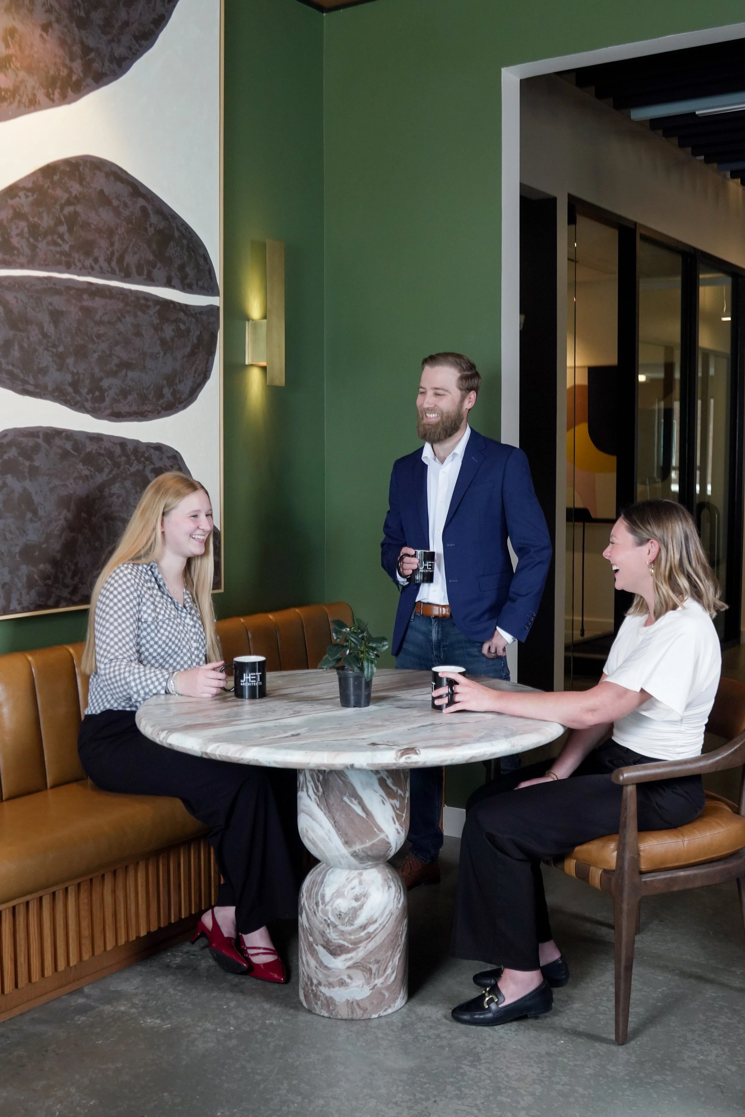 Corporate employees meeting in a modern workspace for authentic lifestyle photography.