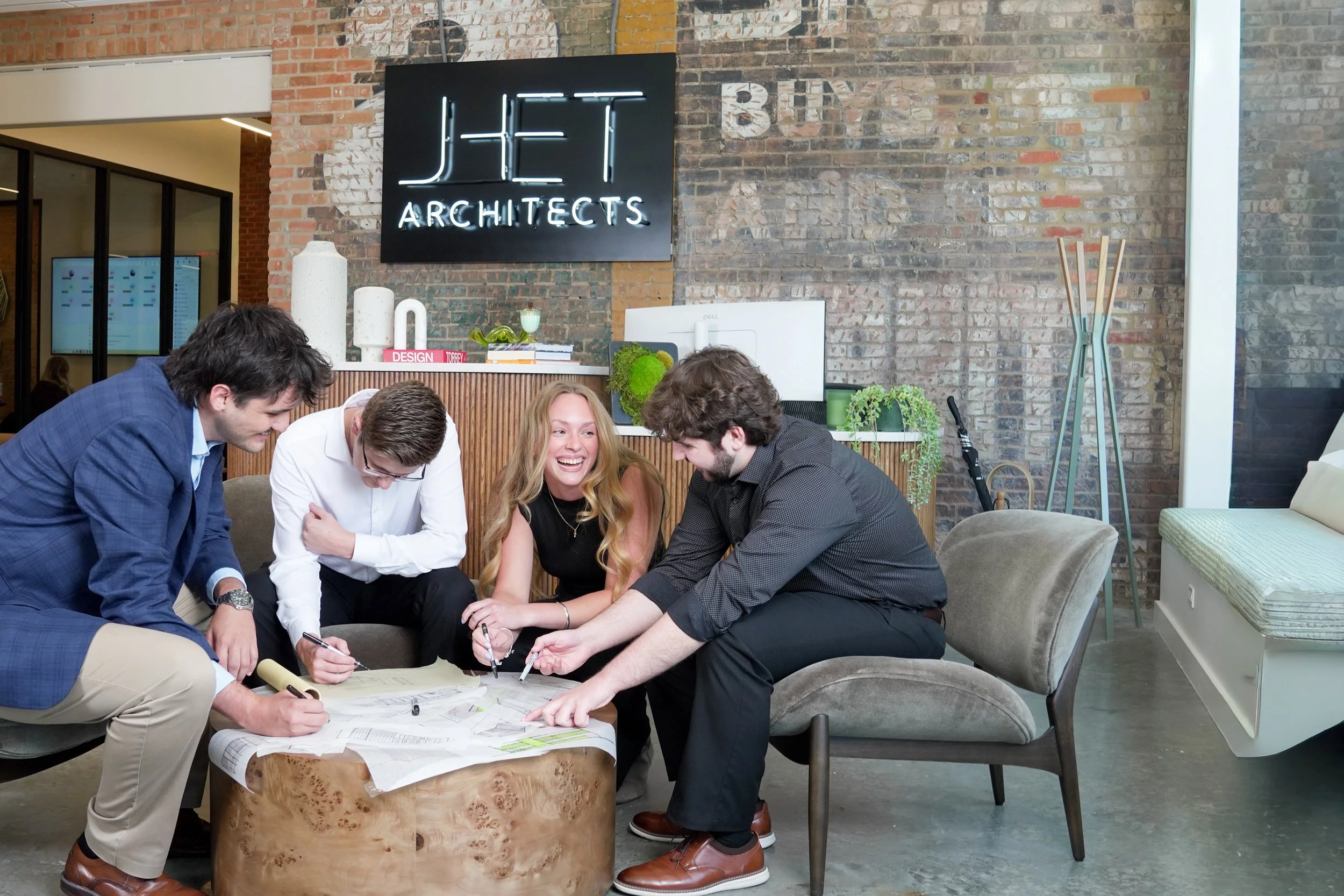 Employees collaborating naturally during a corporate workplace photography session.