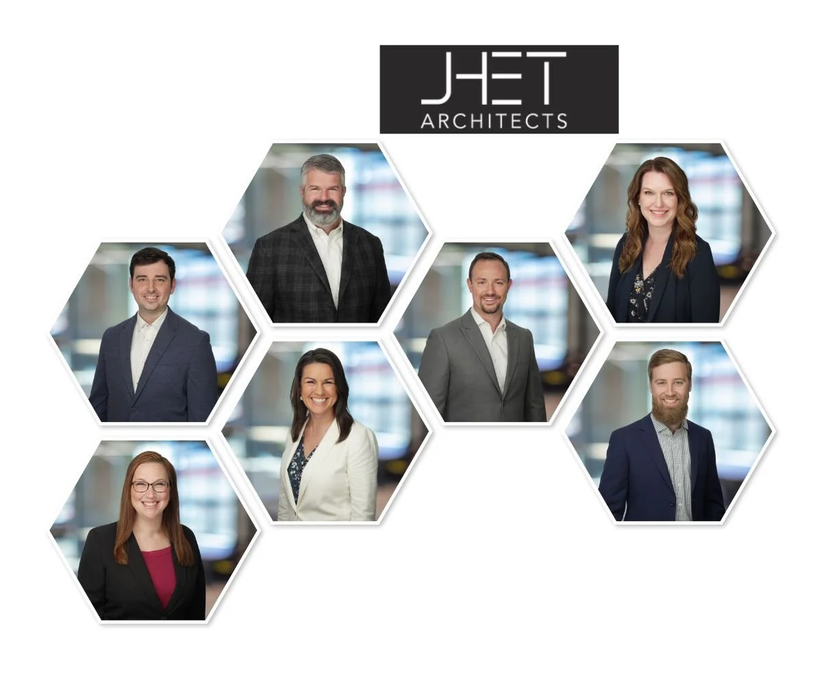 Group photo of six business professionals with a JET Architects logo at the top, arranged in hexagons against a blurred office background.