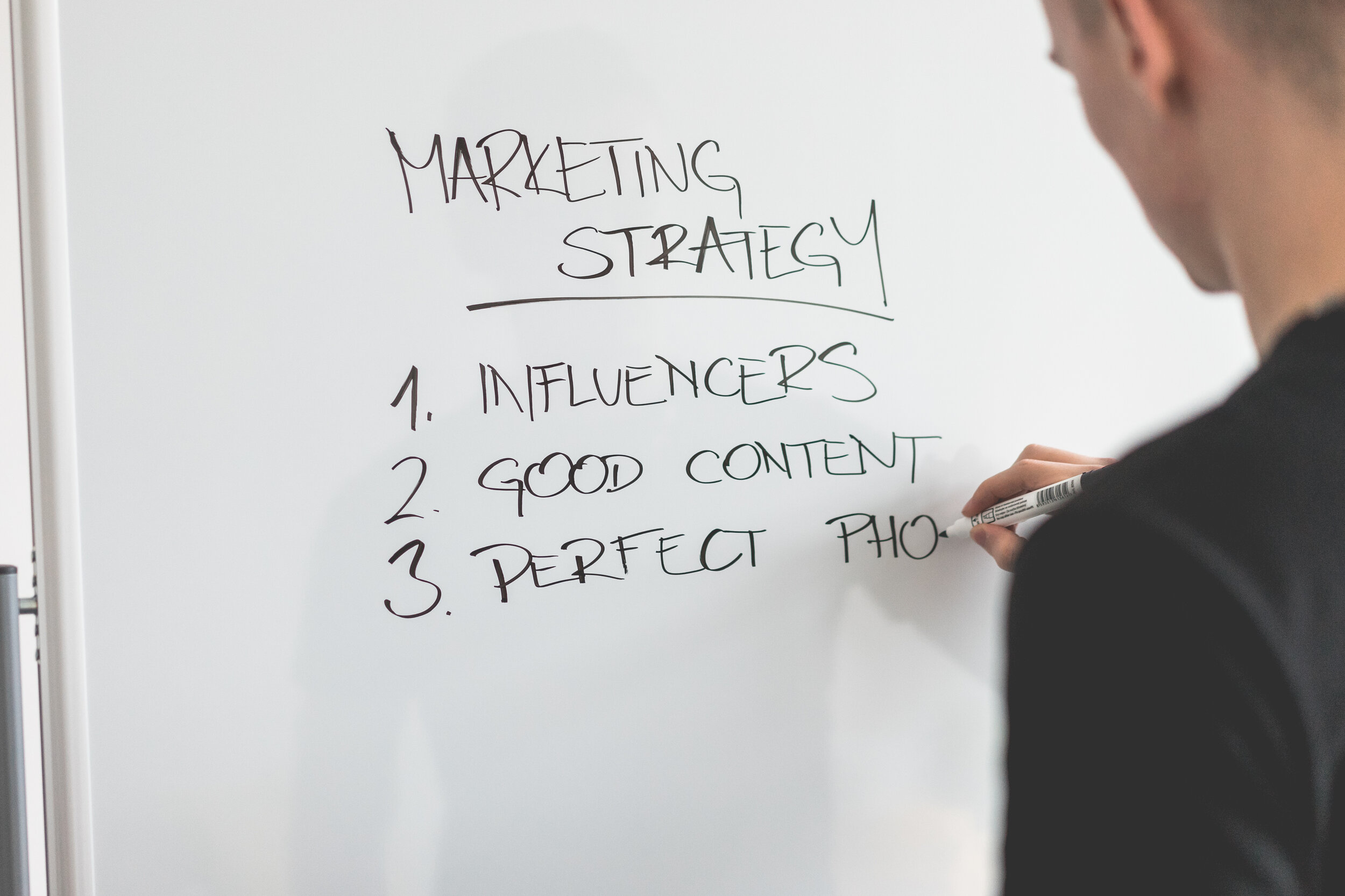 marketing-expert-writing-new-marketing-strategy-on-whiteboard-picjumbo-com.jpg