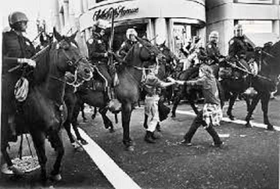 Two very young punks confronted by a phalanx of mounted police, Union Square, July 1984.