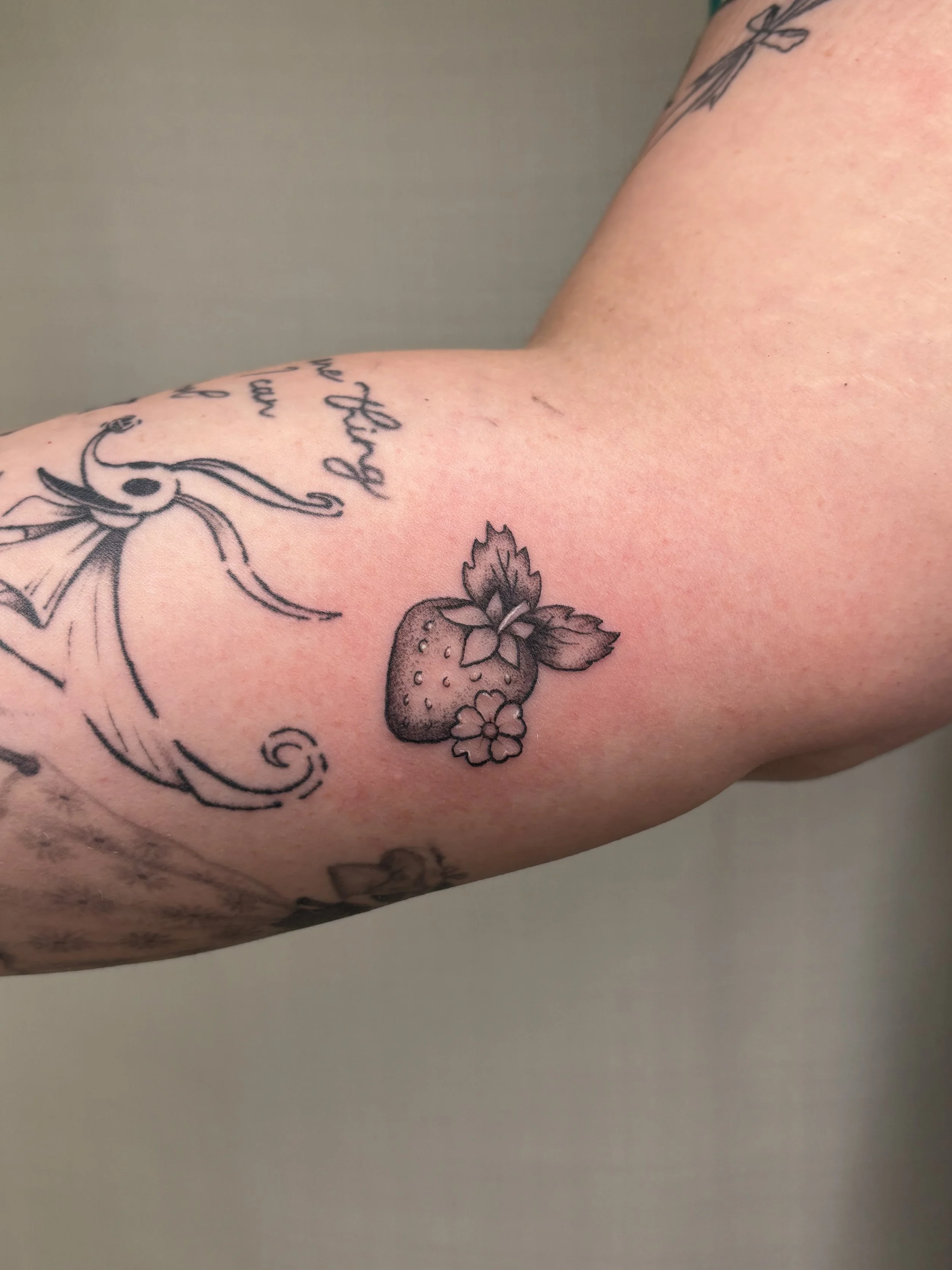 A tattoo of a strawberry