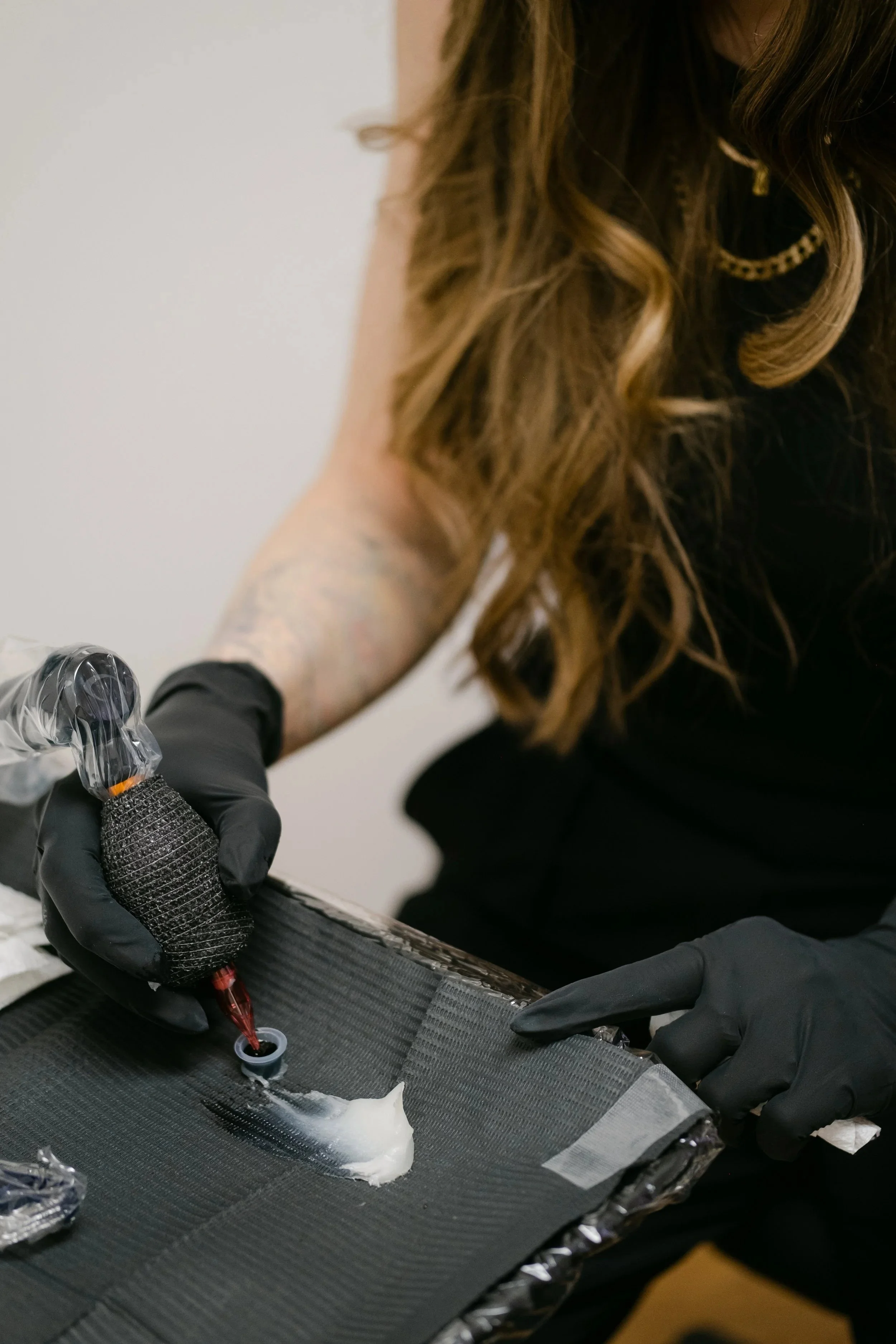 Close-up of a tattoo artist (Jen) creating a detailed tiger tattoo at Rebel & Rose Tattoo Studio in Westport, CT -- a women-owned luxury tattoo studio specializing in fine line, realism, scar camouflage, and areola tattooing