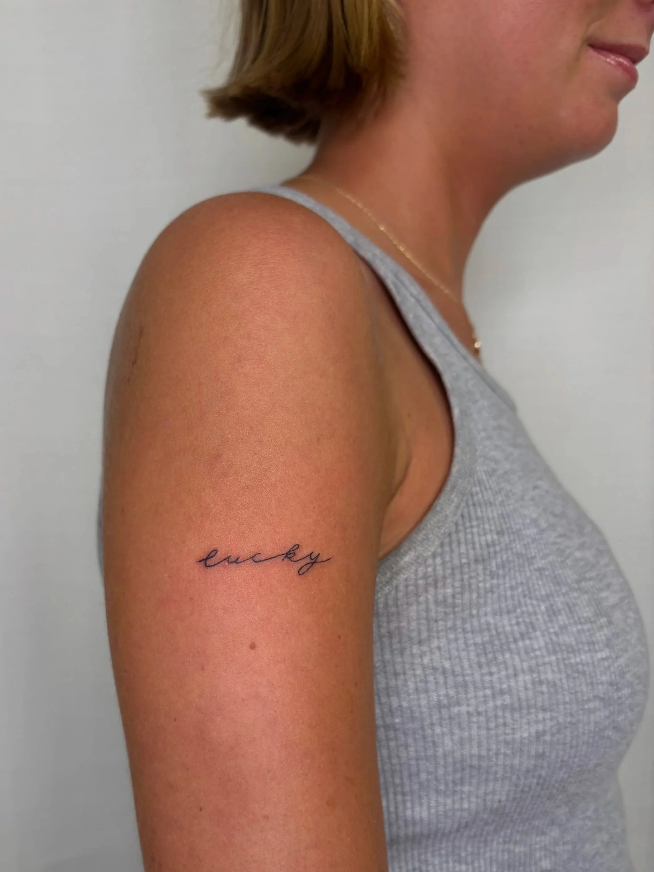 A tattoo that says "lucky" done by Brooke Kalynn