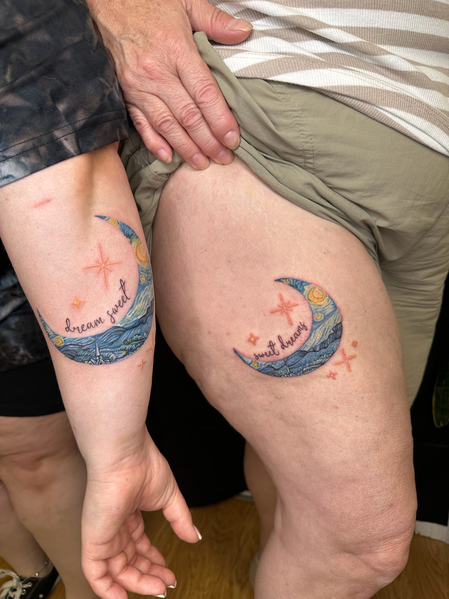 Two colorful Van Goh inspired moon tattoos with "sweet dreams" written above 