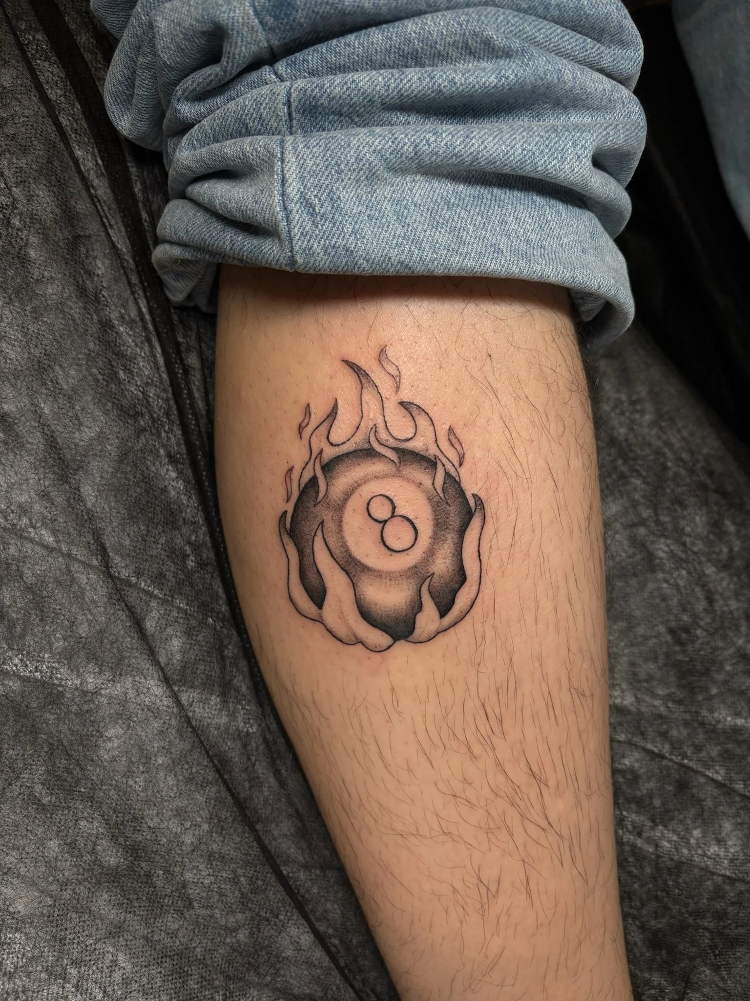 A tattoo of an 8 ball with flames