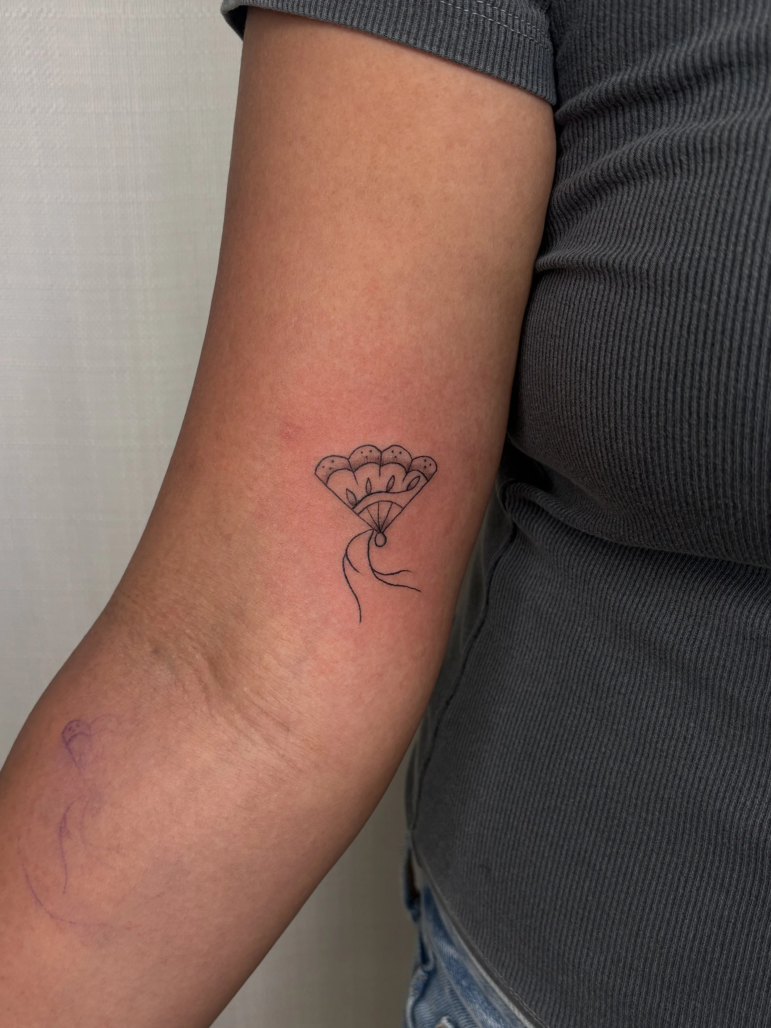 A photo of a fan tattoo done by Brooke Kalynn