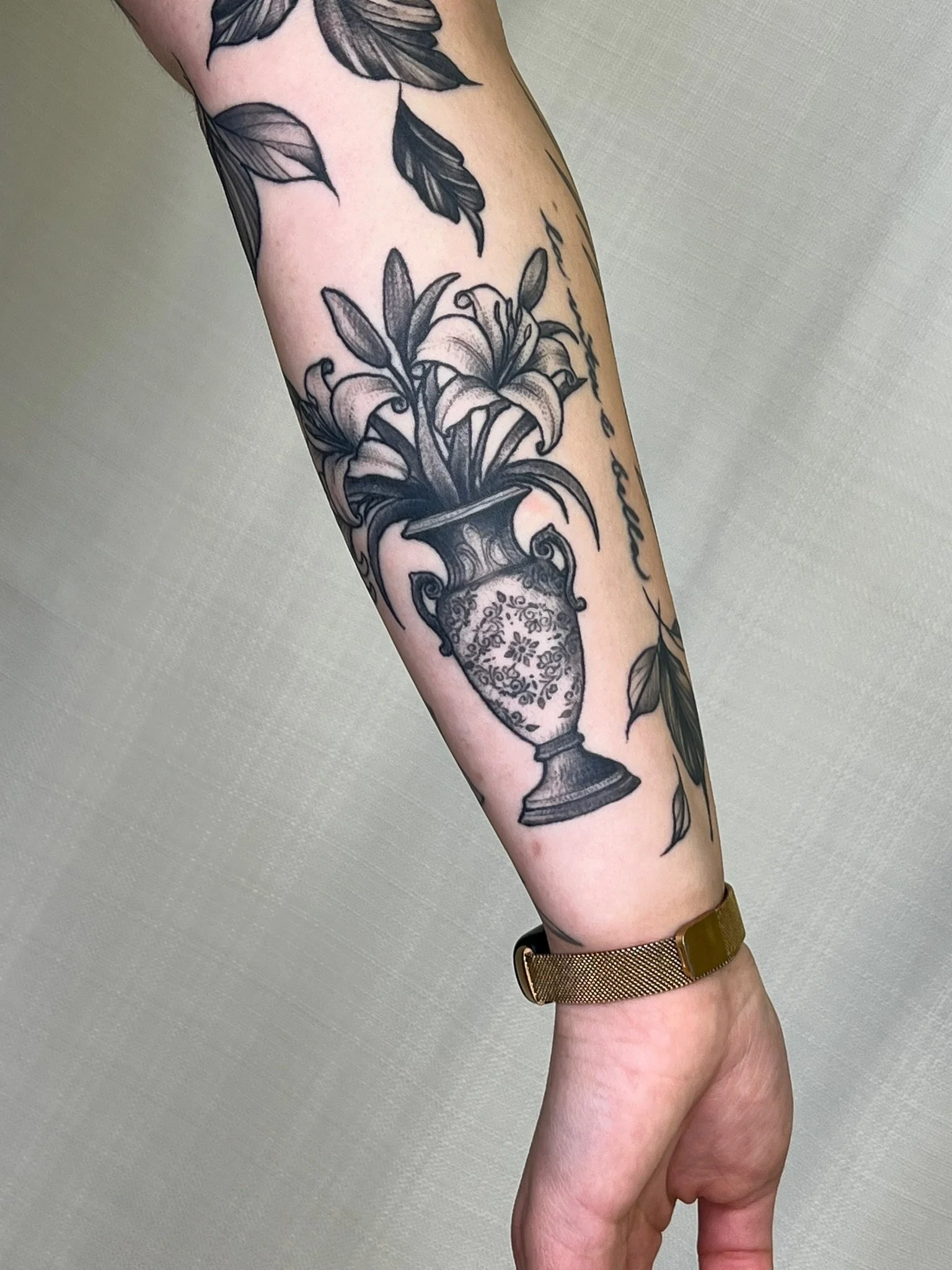 An Italian inspired vintage vase tattoo with lillies