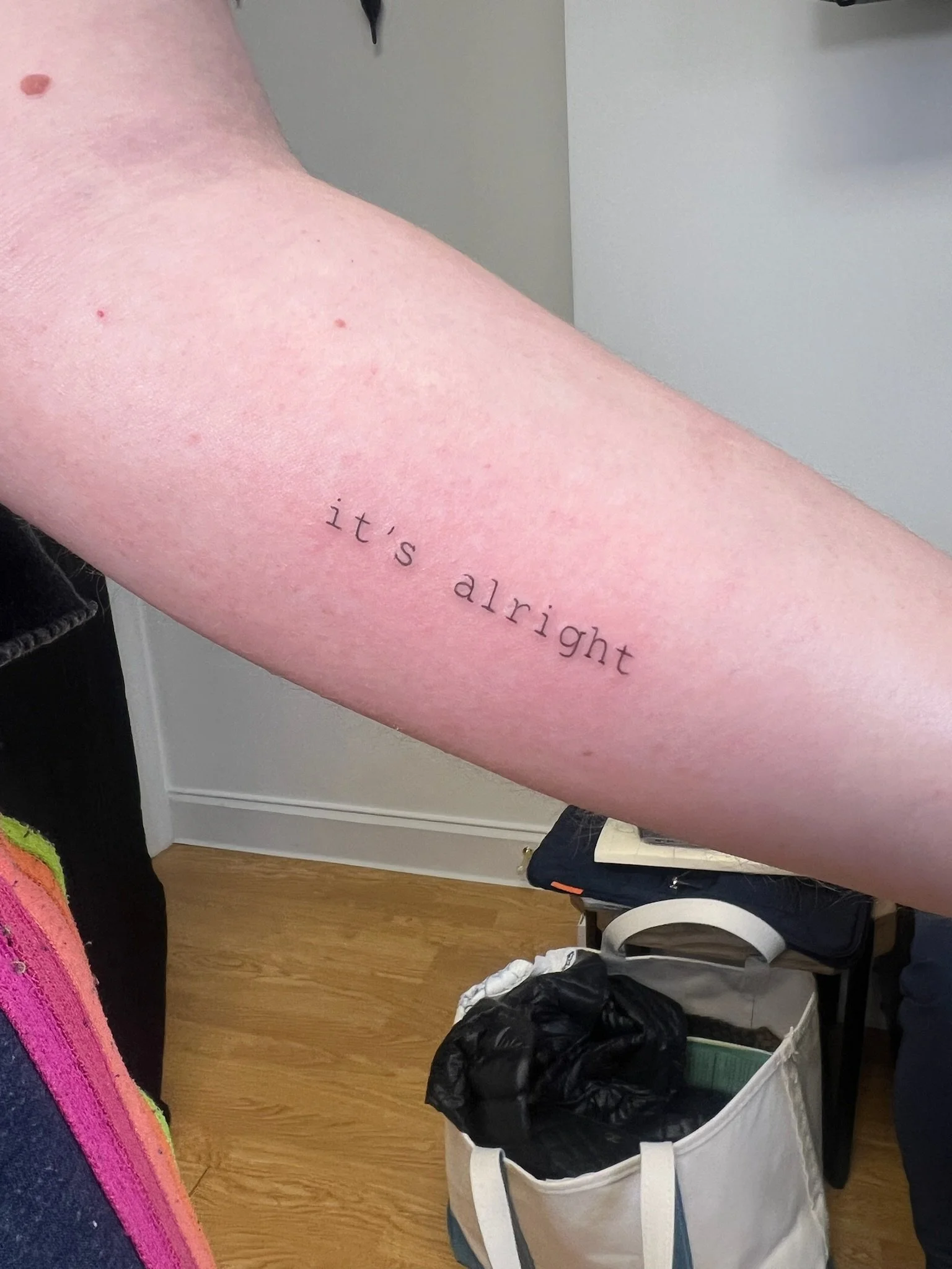 A tattoo that says "it's alright"