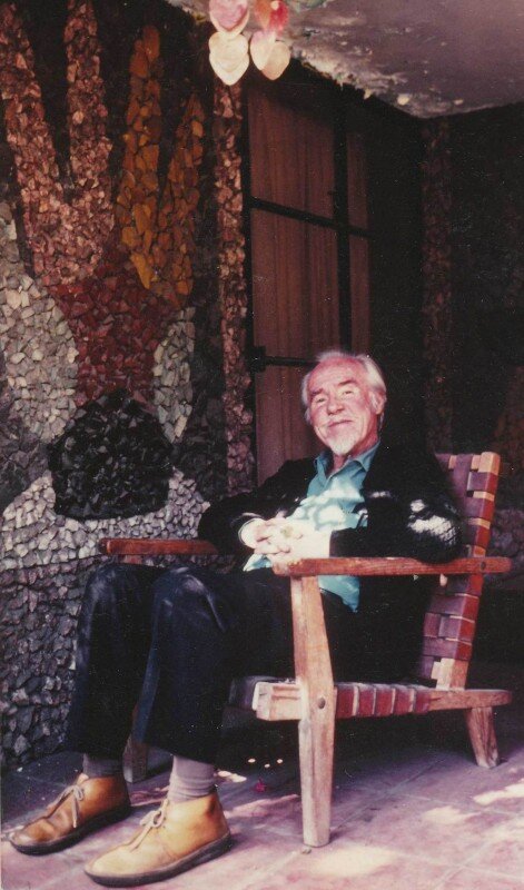 Conlon in later years in front of a Juan O'Gorman mural in Mexico City.