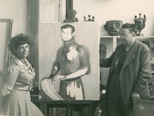 Annette with Diego at the easel.