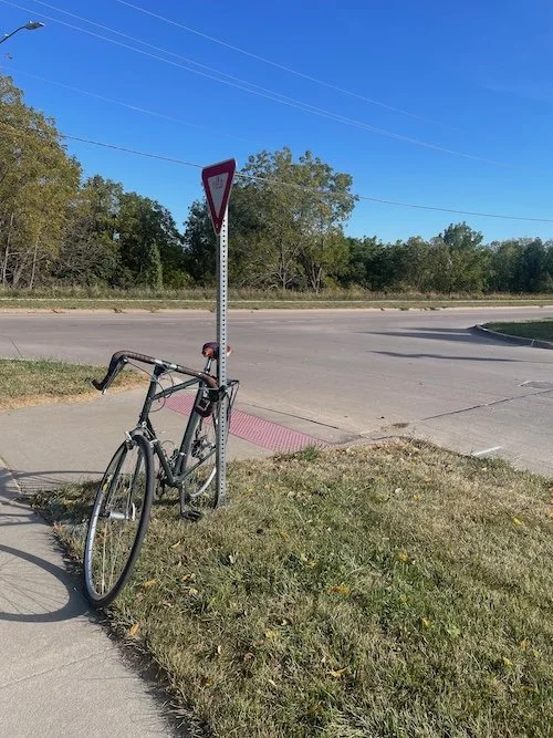 Bike next to a sidewalk.